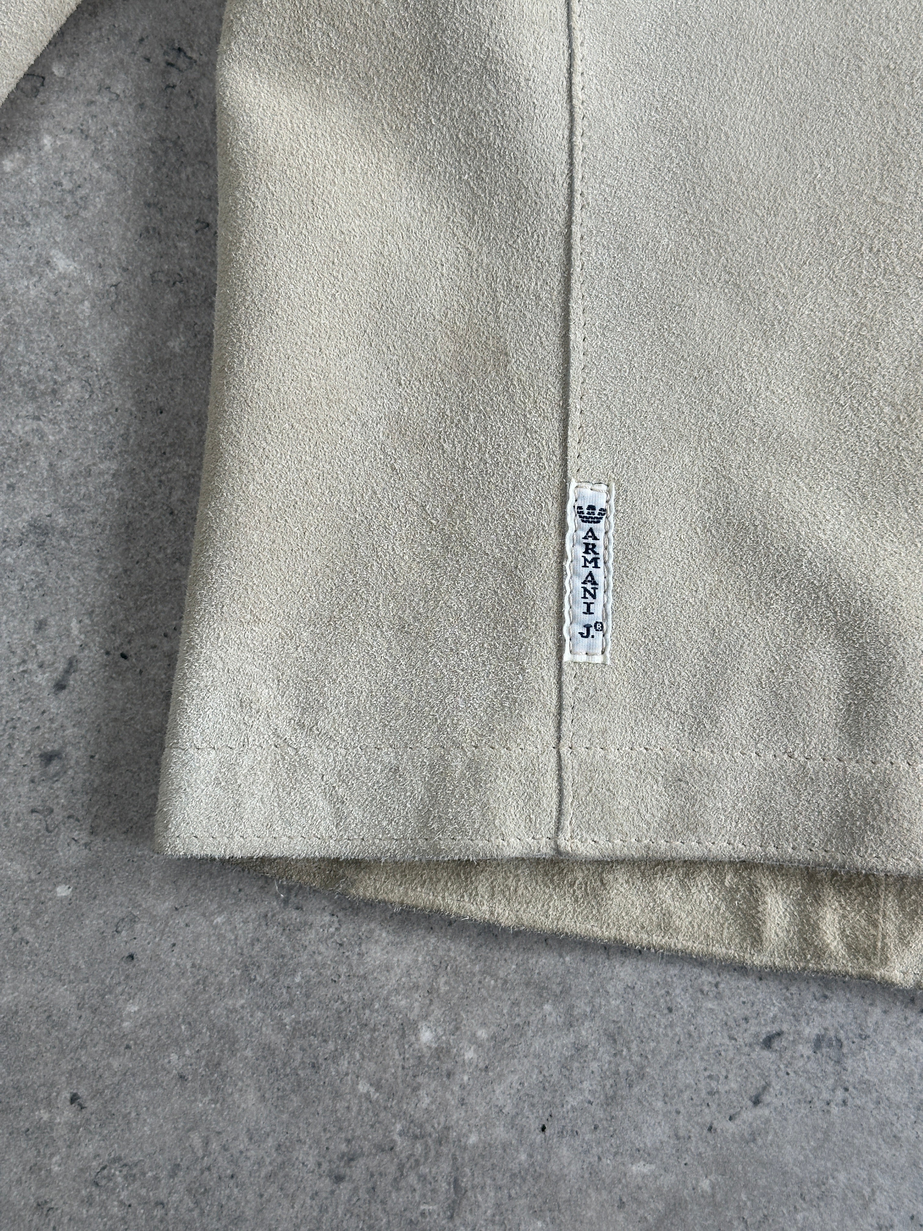 Armani Jeans fitted suede jacket in XS/S, stylish brown jacket with a sleek design and classic collar, displayed on a hanger.