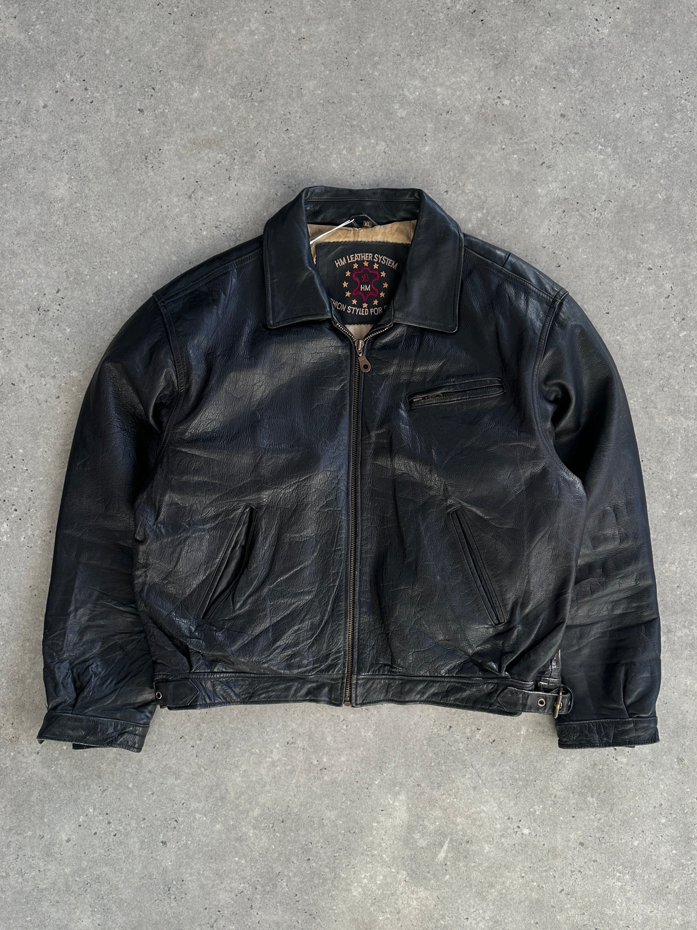 Vintage leather jacket in size XL, featuring classic design and distressed leather texture, displayed on a neutral background.