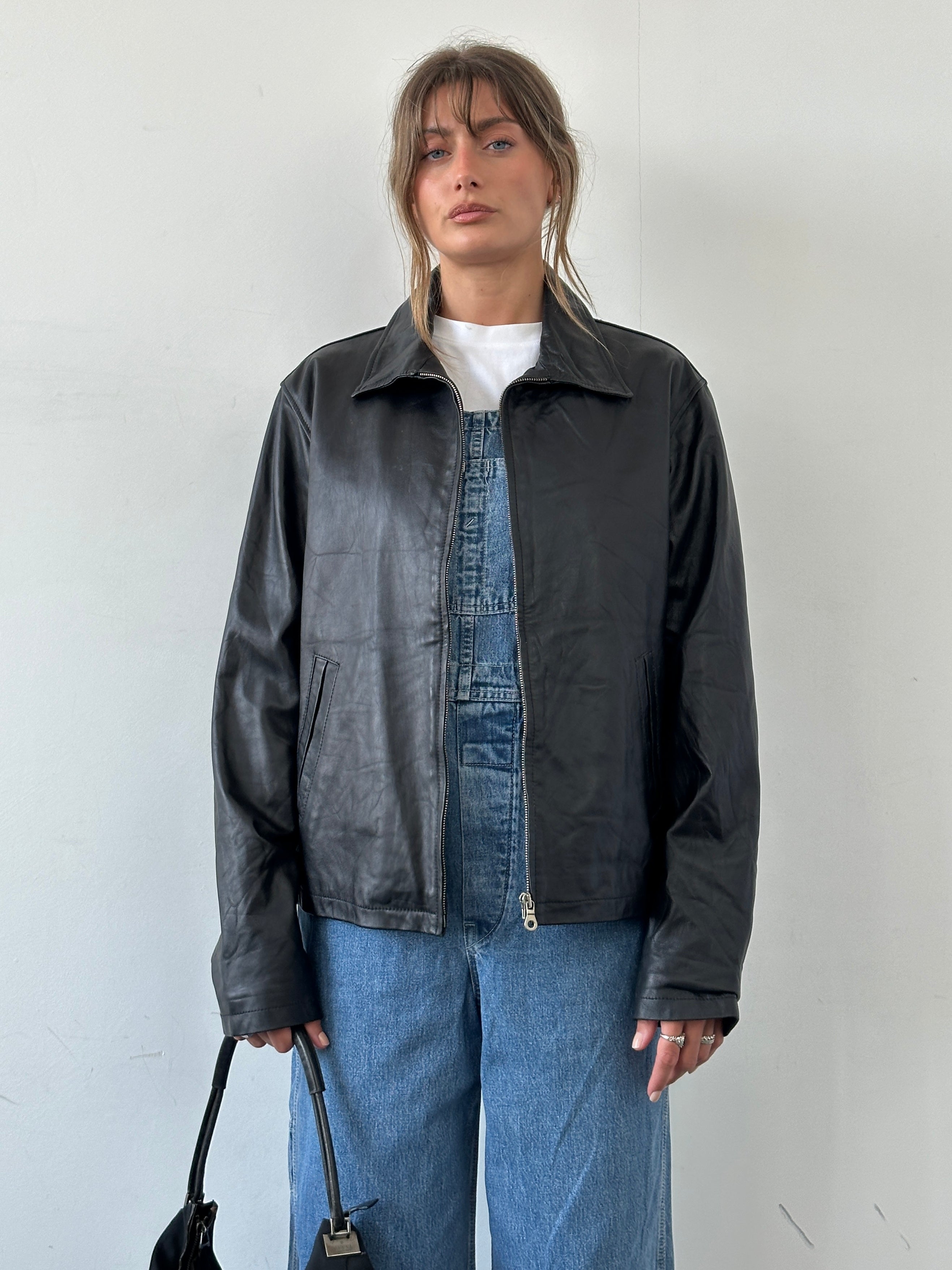 Vintage Italian vintage minimal leather jacket with zip-up front, showcasing a classic design and high-quality leather.