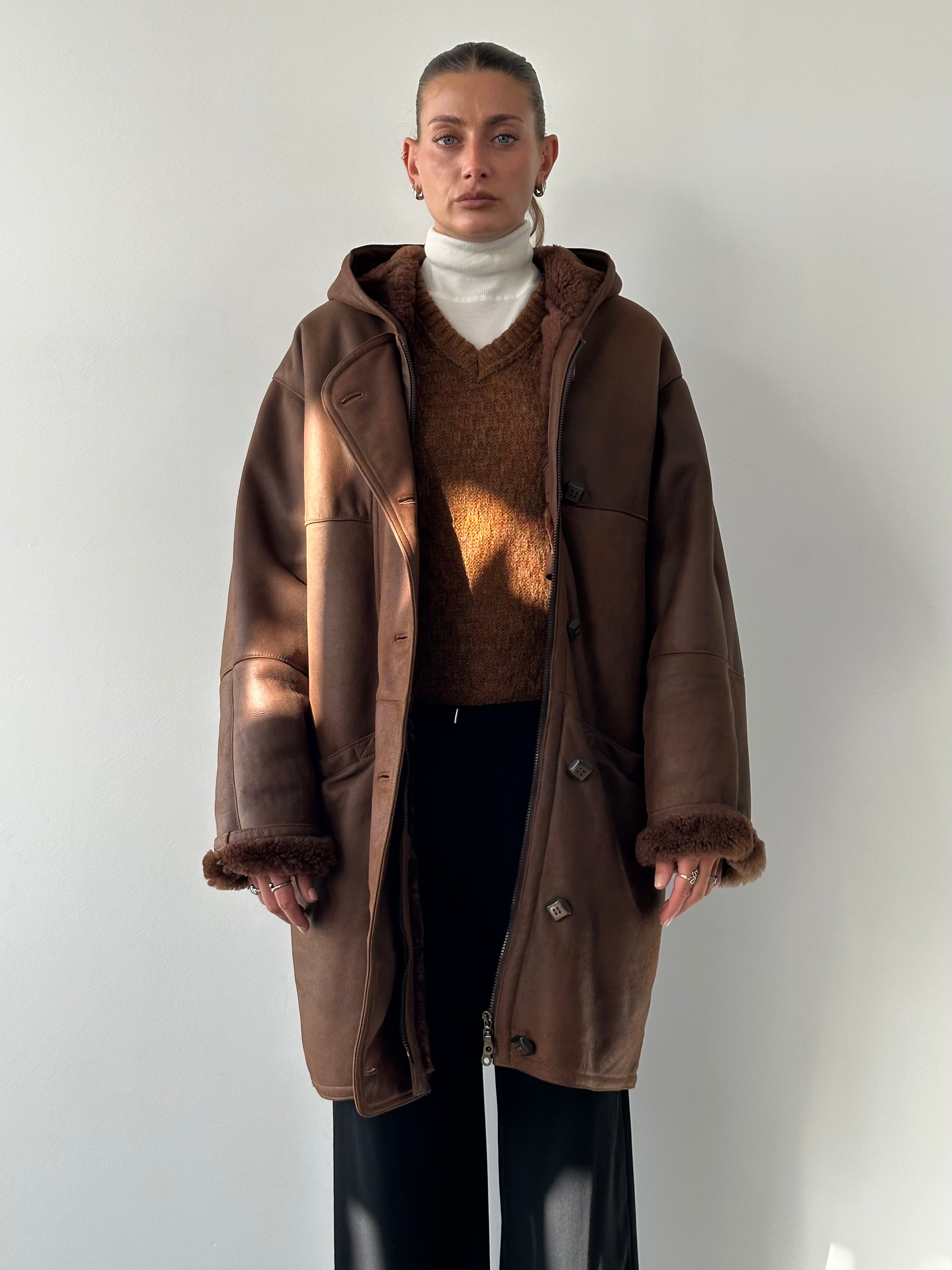 Vintage leather fleece-lined hooded coat, XL jacket with rugged leather exterior and warm fleece interior, casual outerwear style.