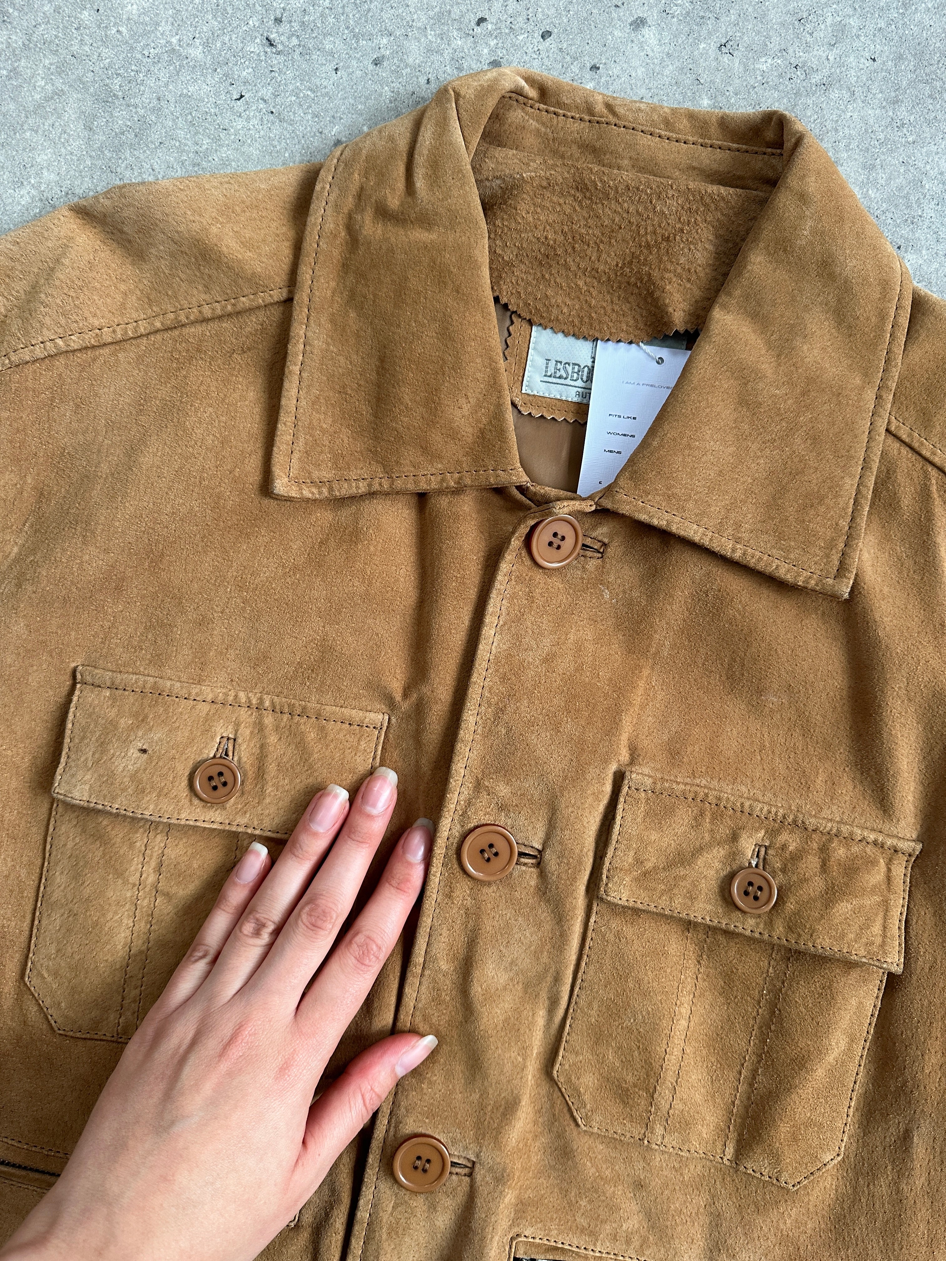 Vintage suede trucker jacket in size M/L, featuring classic design with a rugged, stylish look and detailed stitching.
