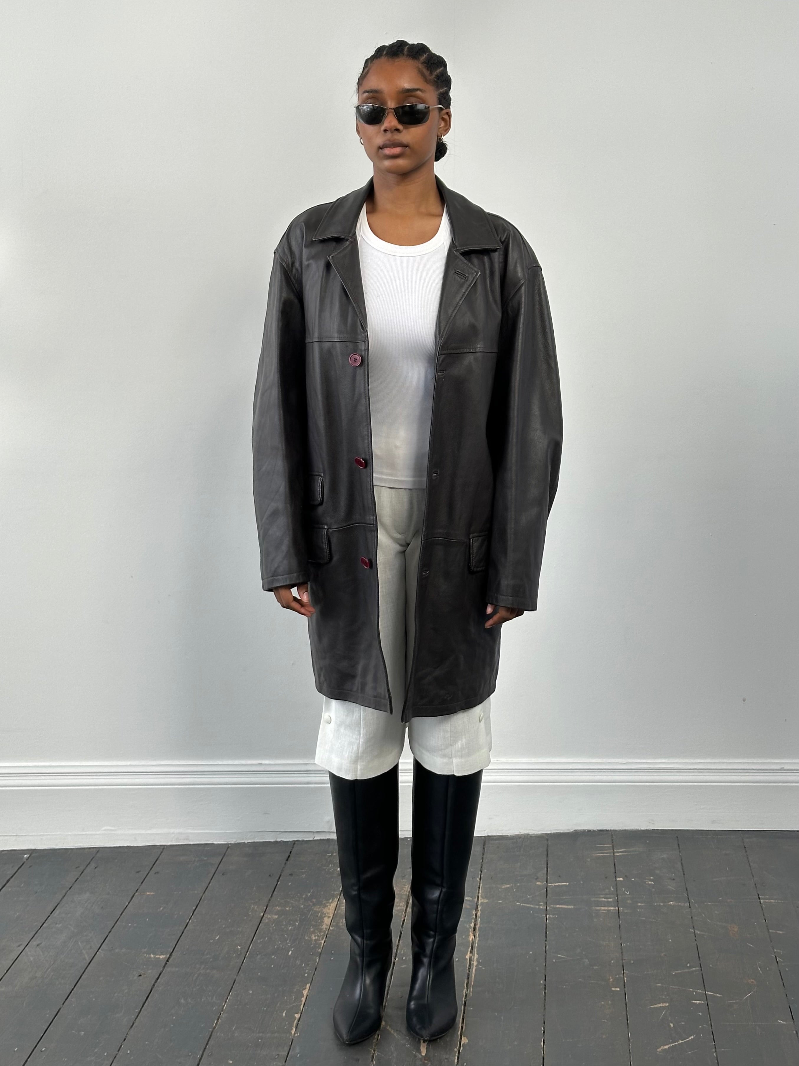 Conbipel 1990s leather trench coat in XL size, featuring classic design and high-quality leather, displayed on a hanger.