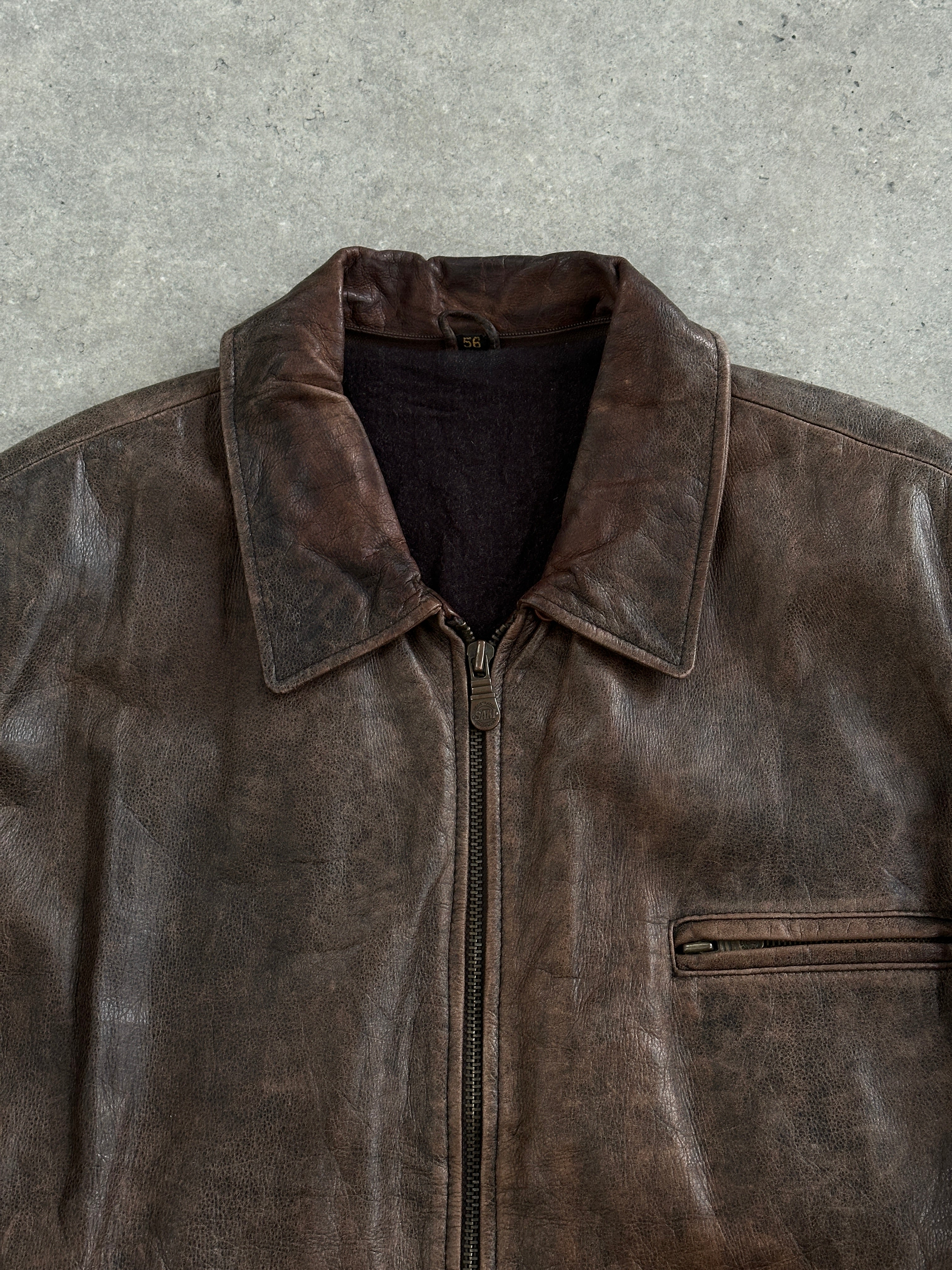Vintage 1990s aged leather jacket in XL size, featuring a classic distressed leather look and vintage style.