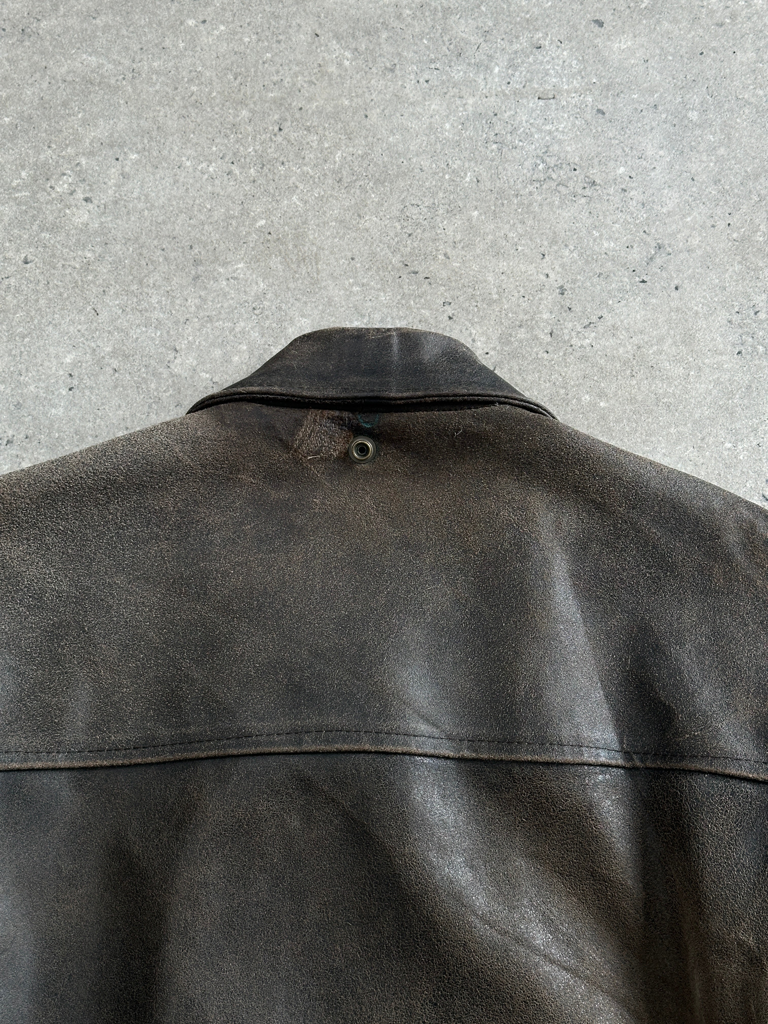 Vintage 1980s distressed leather jacket in XL with rugged texture, classic style, and vintage branding details.