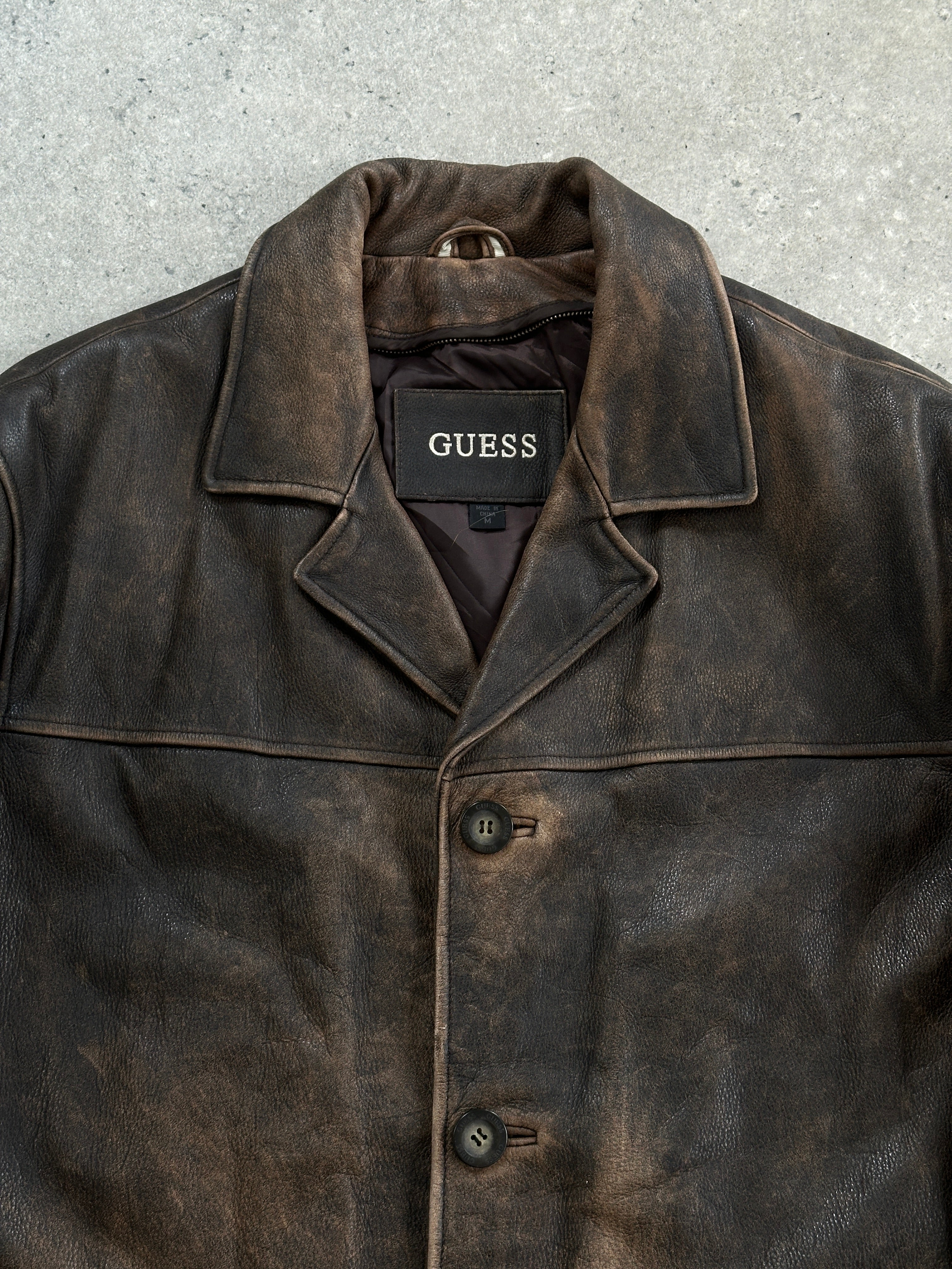 Guess distressed leather jacket in XL size, shown with rugged design and classic collar, made from high-quality leather.