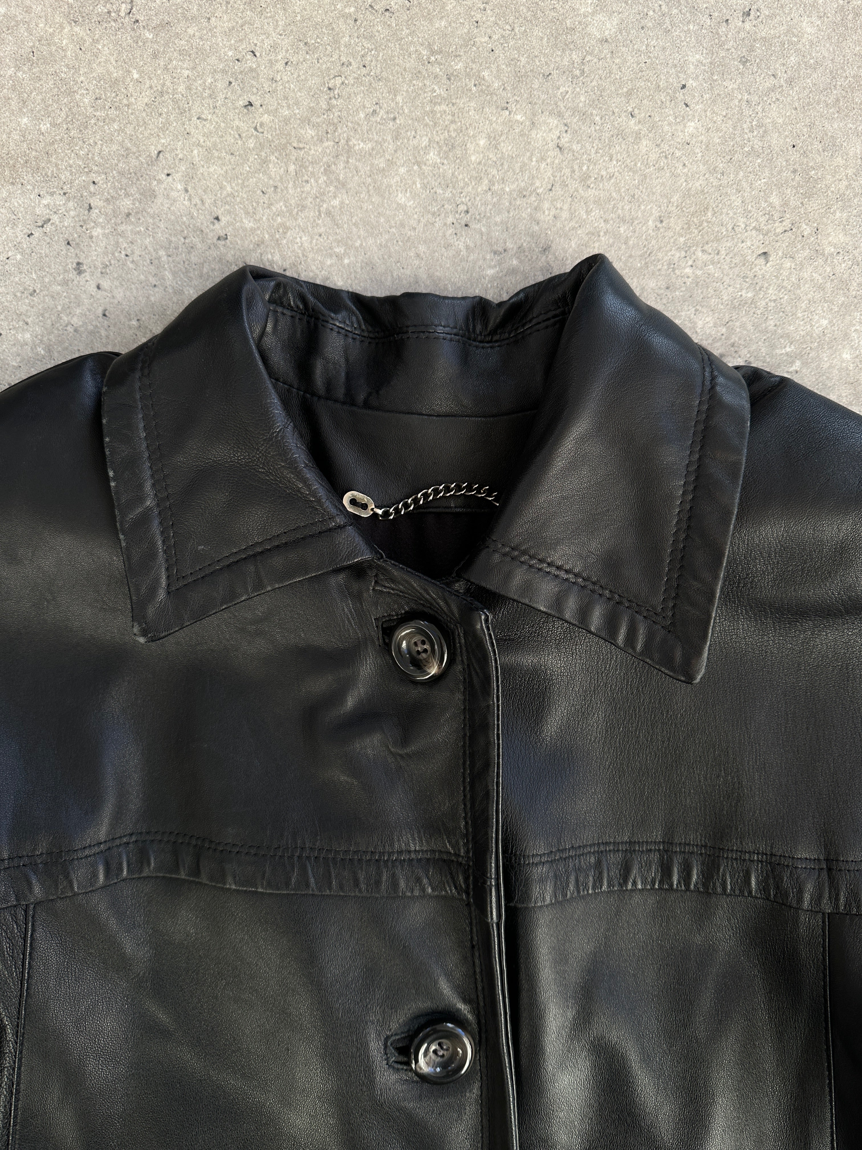 Vintage Italian leather trench coat jacket in size L with classic design and aged finish, featuring a timeless vintage style.
