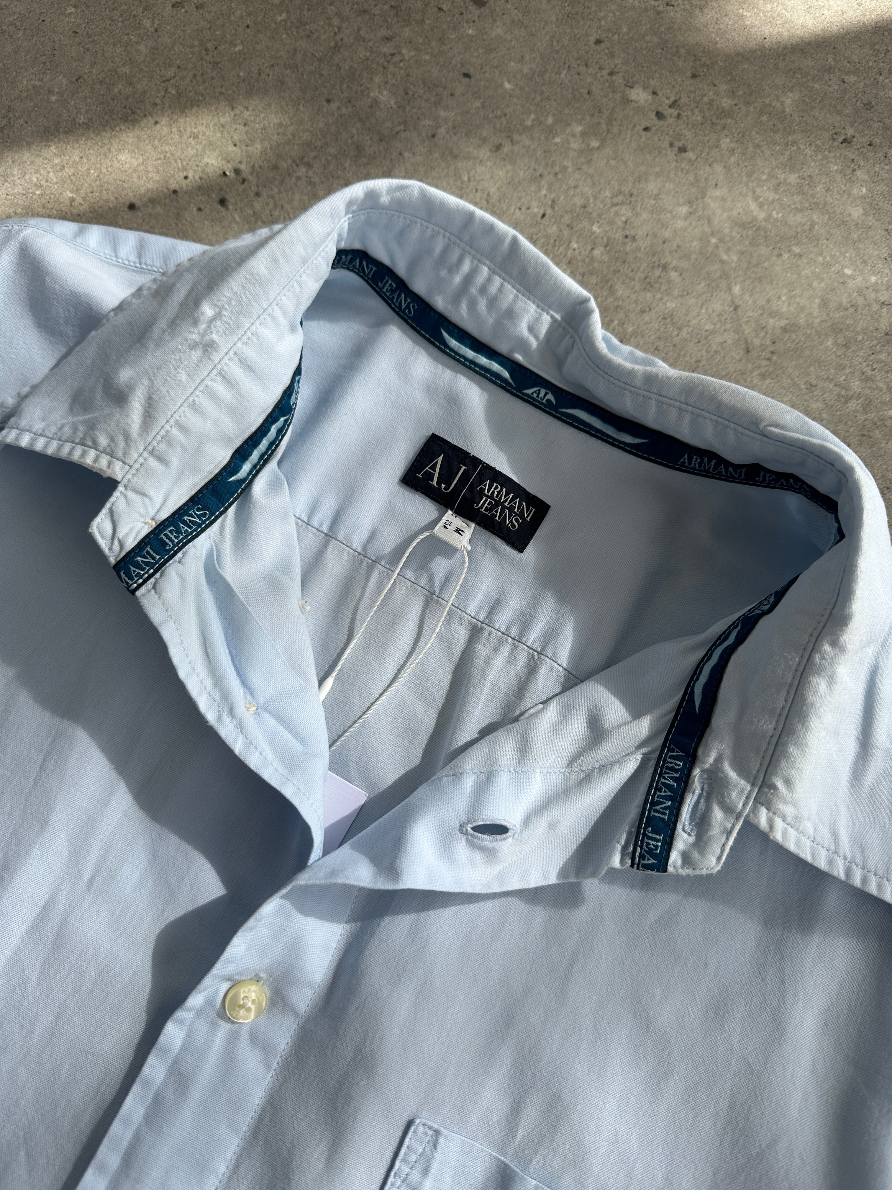 Armani Jeans pure cotton logo shirt in size L, featuring a classic design with the Armani logo on the front.