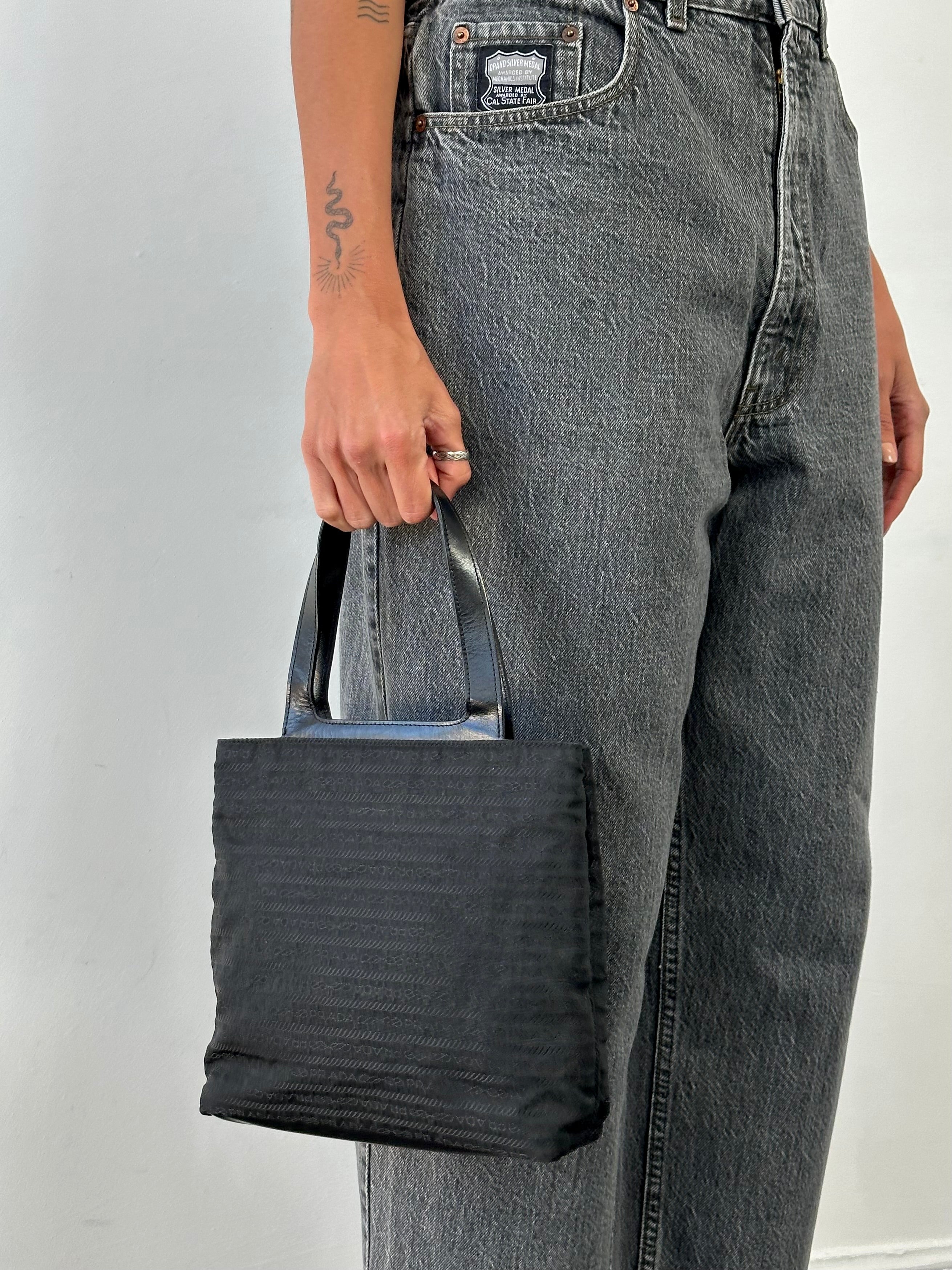 Prada 1990s Tessuto Monogram handbag with top handles, featuring classic monogram fabric and elegant design details.