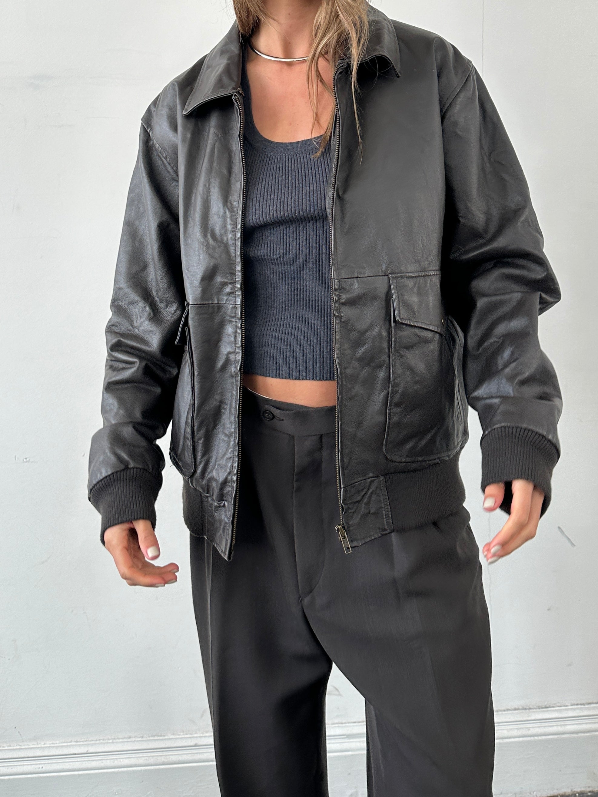 Vintage smooth leather bomber jacket in size large, featuring classic style and a sleek, polished finish.
