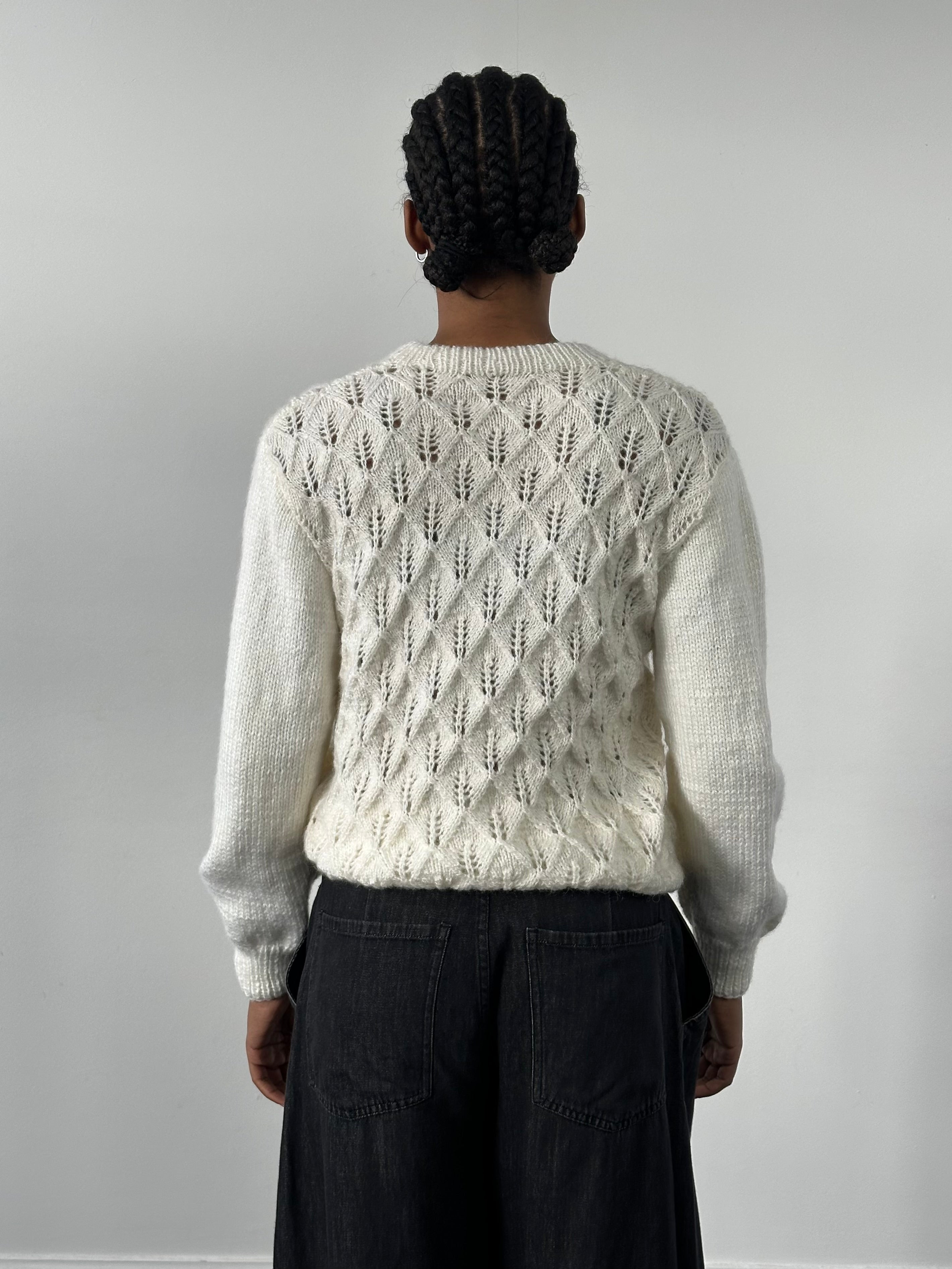 Vintage 1990s wool knit jumper in S/M, cozy sweater with a classic textured design, featuring a round neckline and long sleeves.