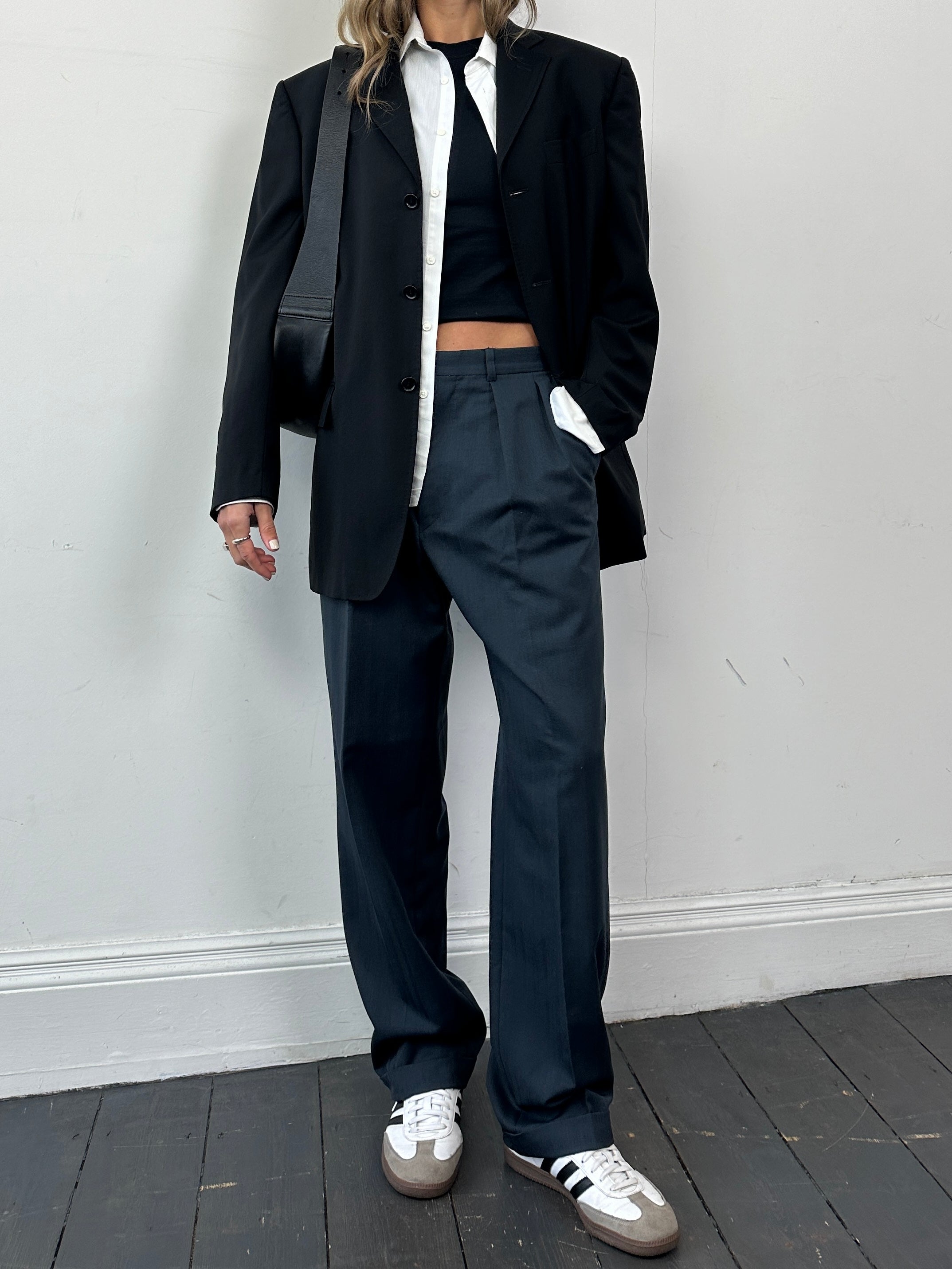 Christian Dior wool tapered leg tailored trousers in a neutral color, front view showing classic fit and smooth fabric.