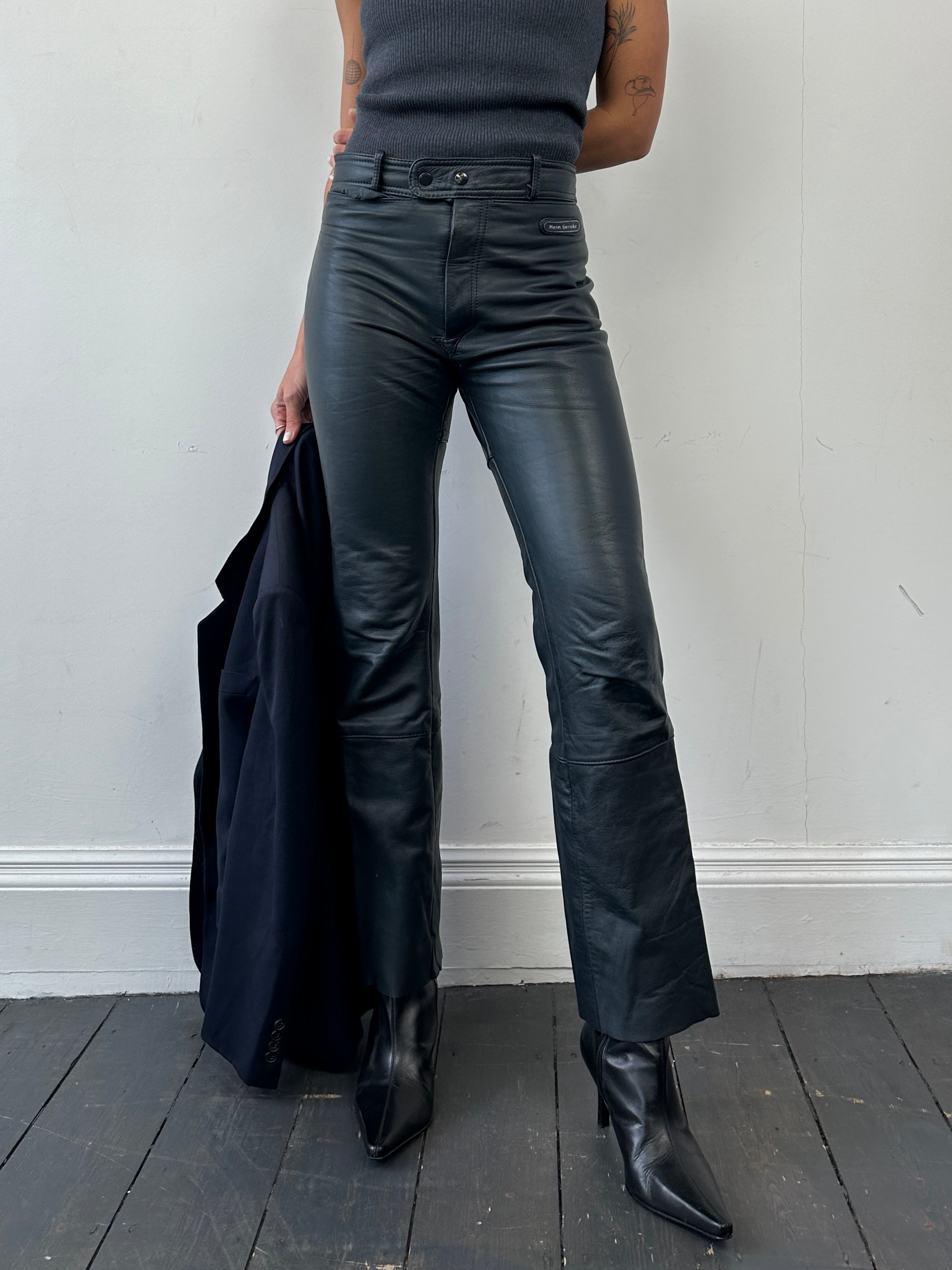 Vintage leather straight leg trousers in size W28, showcasing their classic fit and rich leather texture.