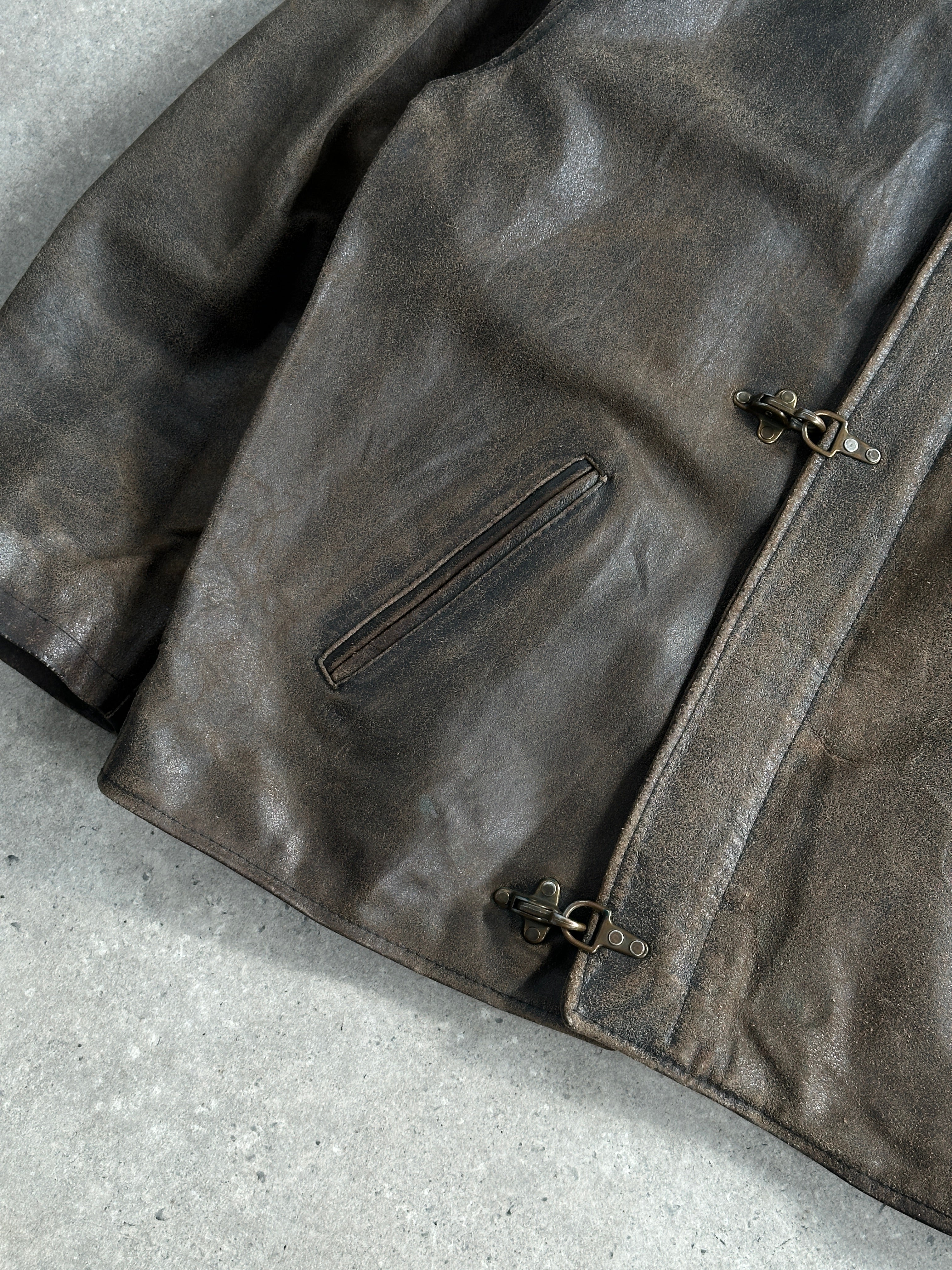 Vintage brand distressed leather jacket from the 1980s, oversized XL size, with a rugged, worn-in look and classic leather texture.
