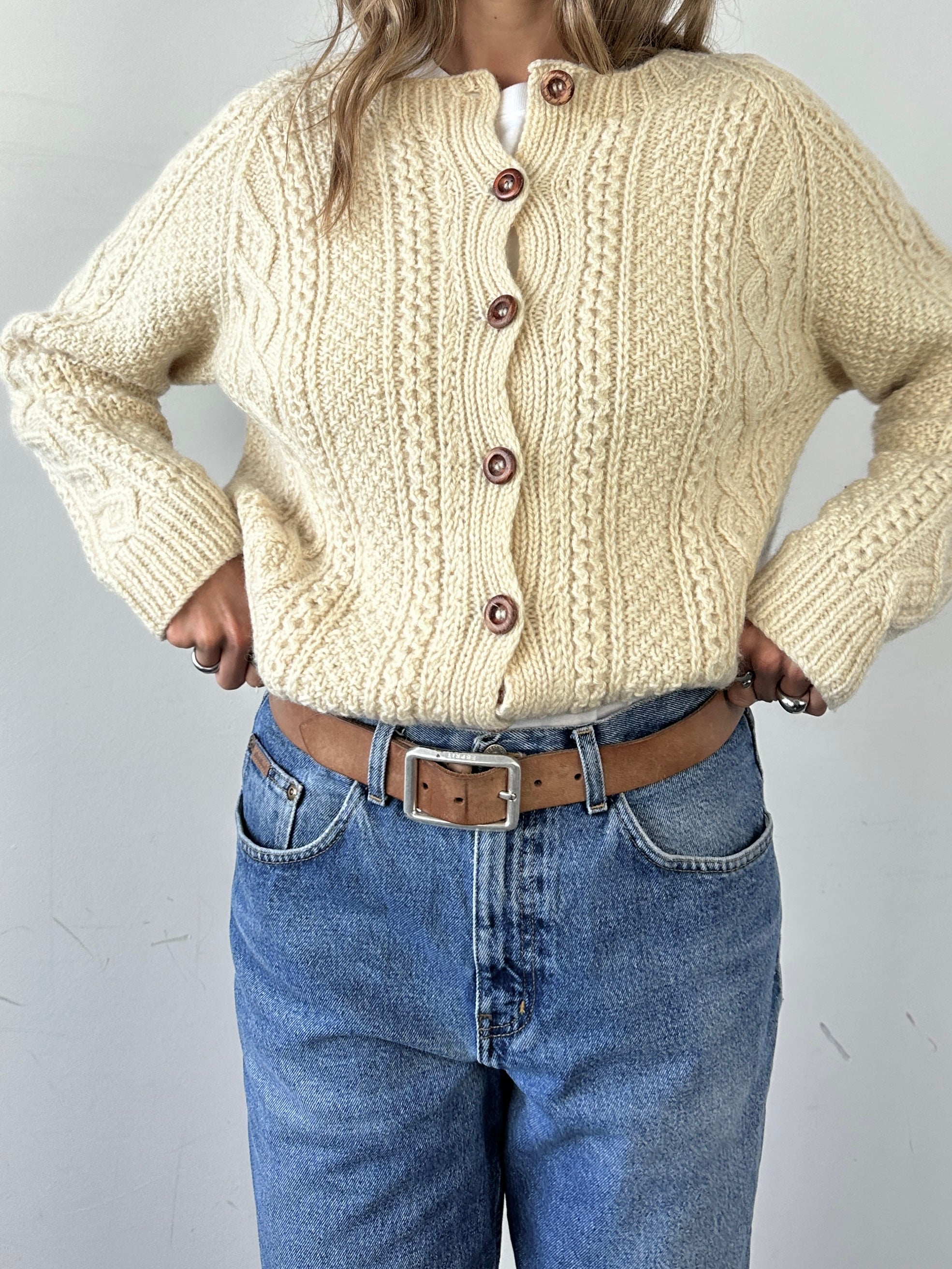 Vintage wool cable knit cardigan in size large, featuring textured patterns and classic design, made by Vintage.