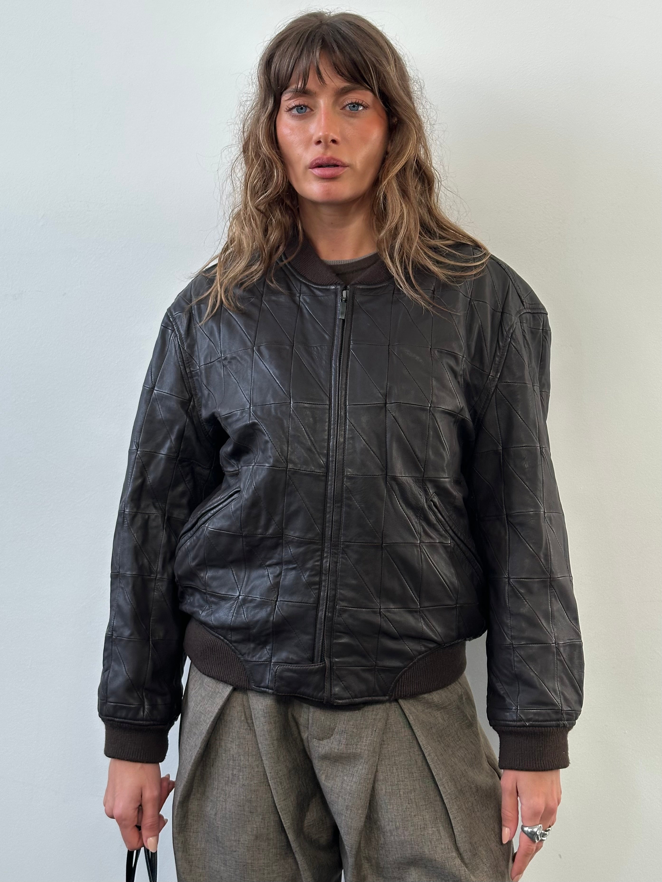 Armani Collezioni 2000s leather bomber jacket in black, featuring a classic design, front zipper, and ribbed cuffs, size S/M.