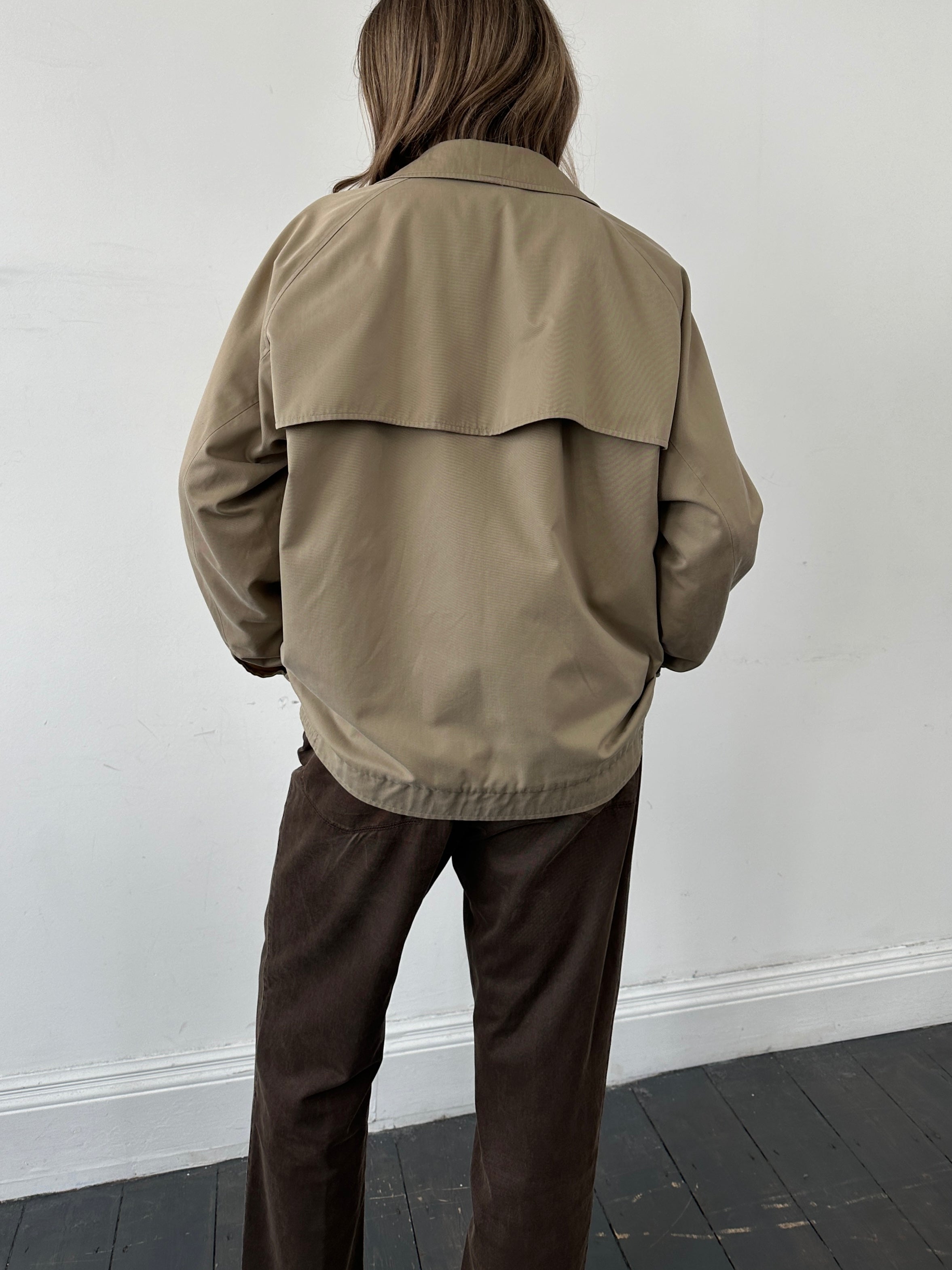 Burberry Nova Check bomber jacket in size L, featuring classic check pattern and stylish design, displayed on a hanger.