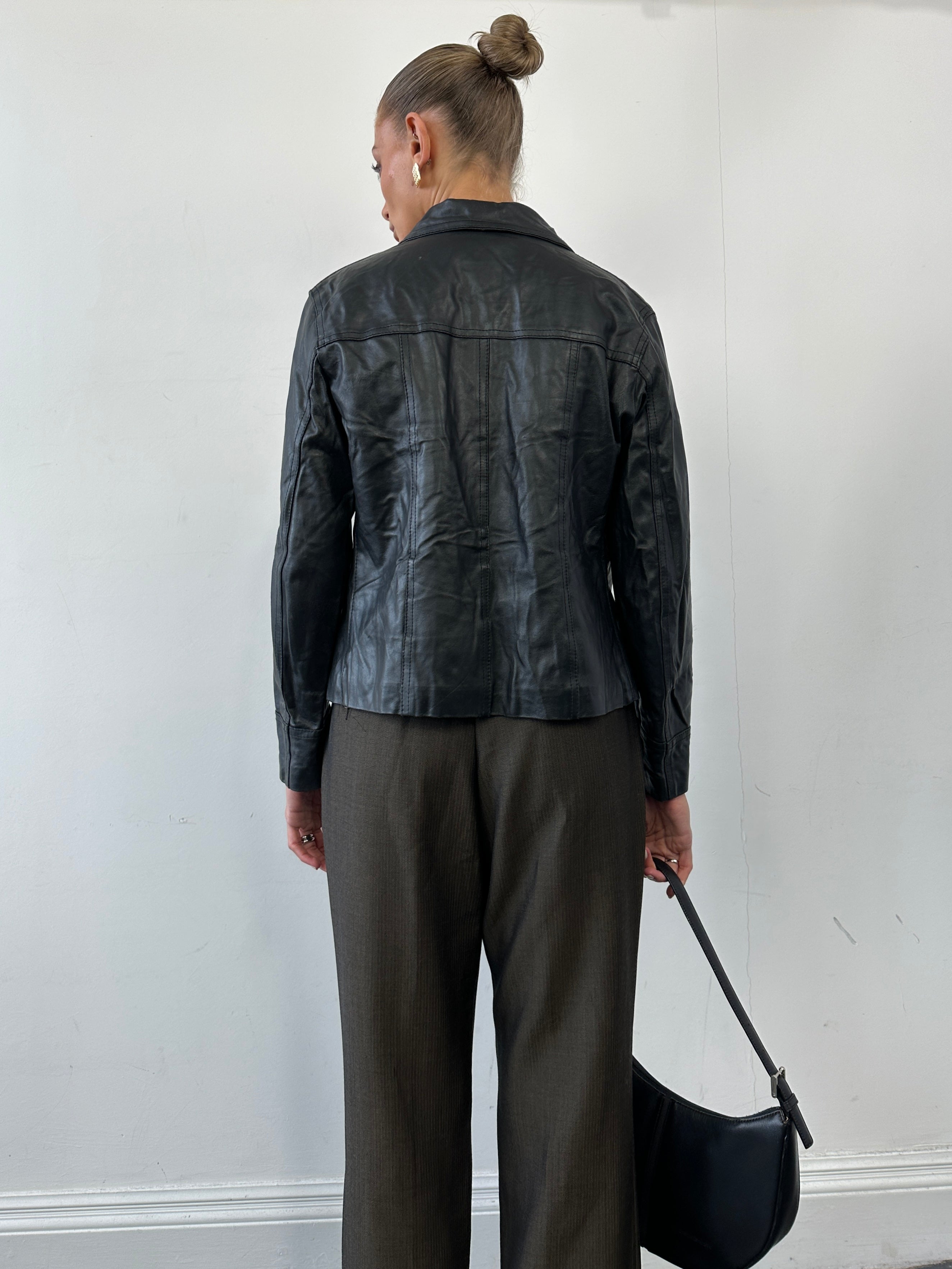 Vintage minimal zip-up leather jacket in size small, featuring a sleek design and classic leather texture.