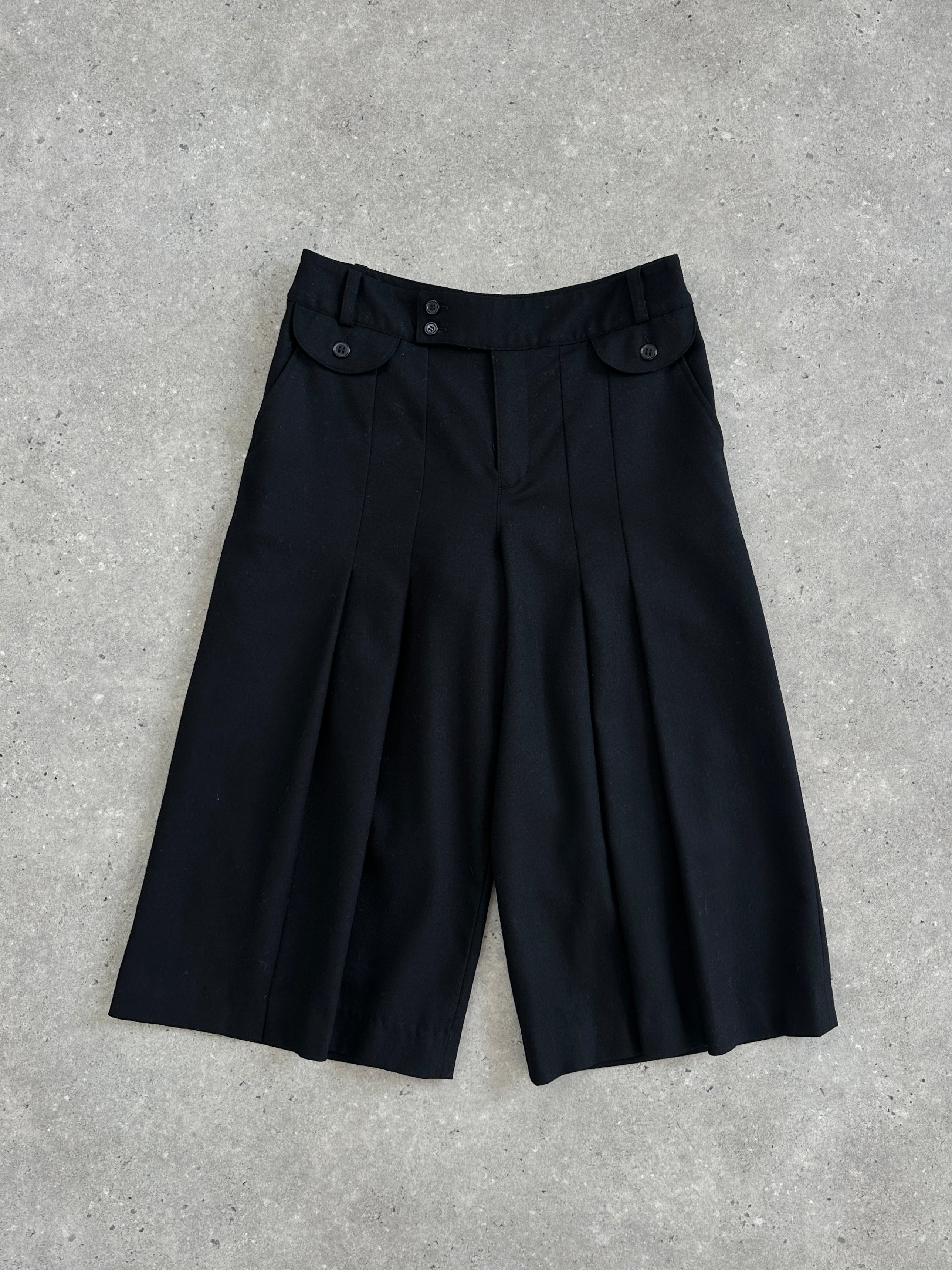 Vintage 1990s wool pleated culottes shorts in neutral tones, high waist with wide pleats, casual retro style.