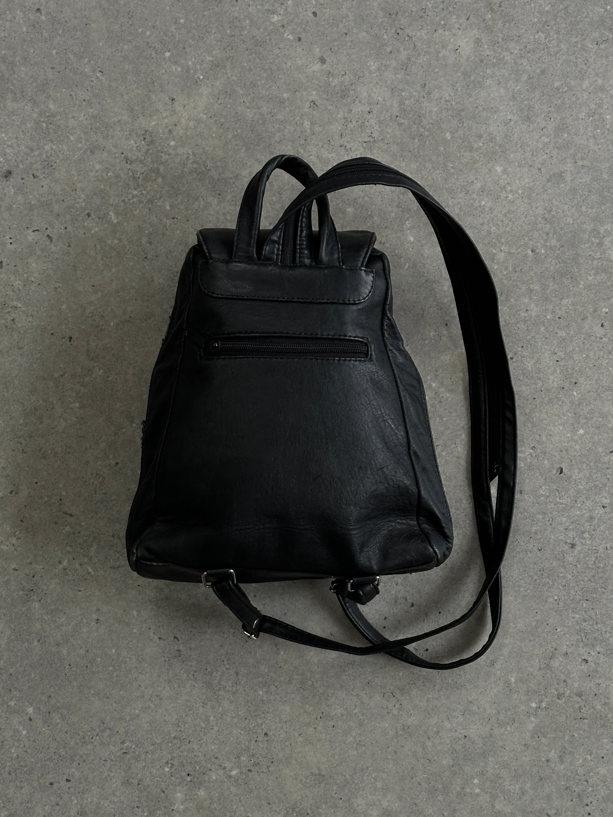 Vintage faux leather rucksack bag with adjustable straps and front pocket, featuring a classic, stylish design.