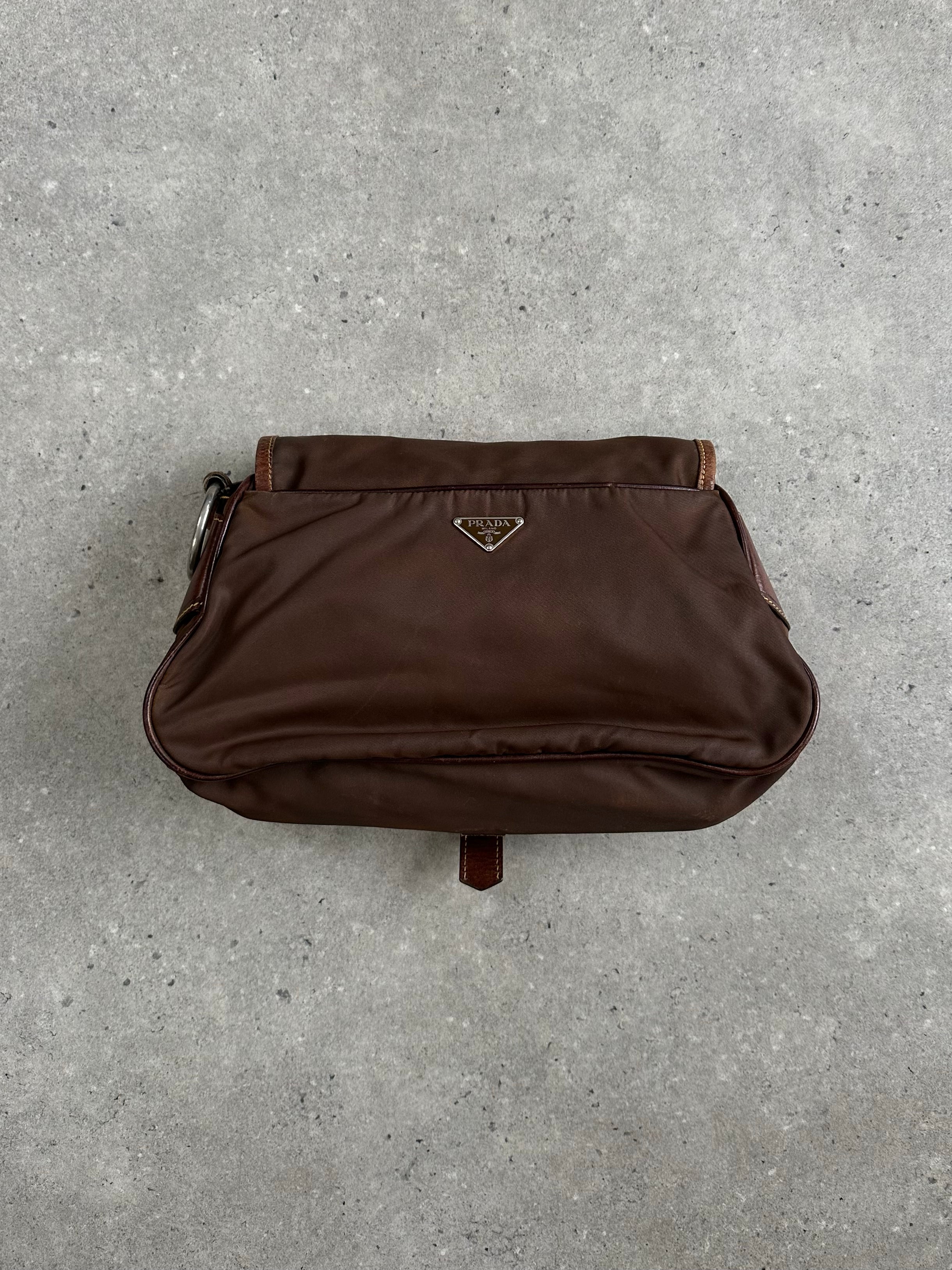 Prada 1990s nylon crossbody bag with adjustable strap and logo detail, showcasing a sleek, vintage-style accessory.