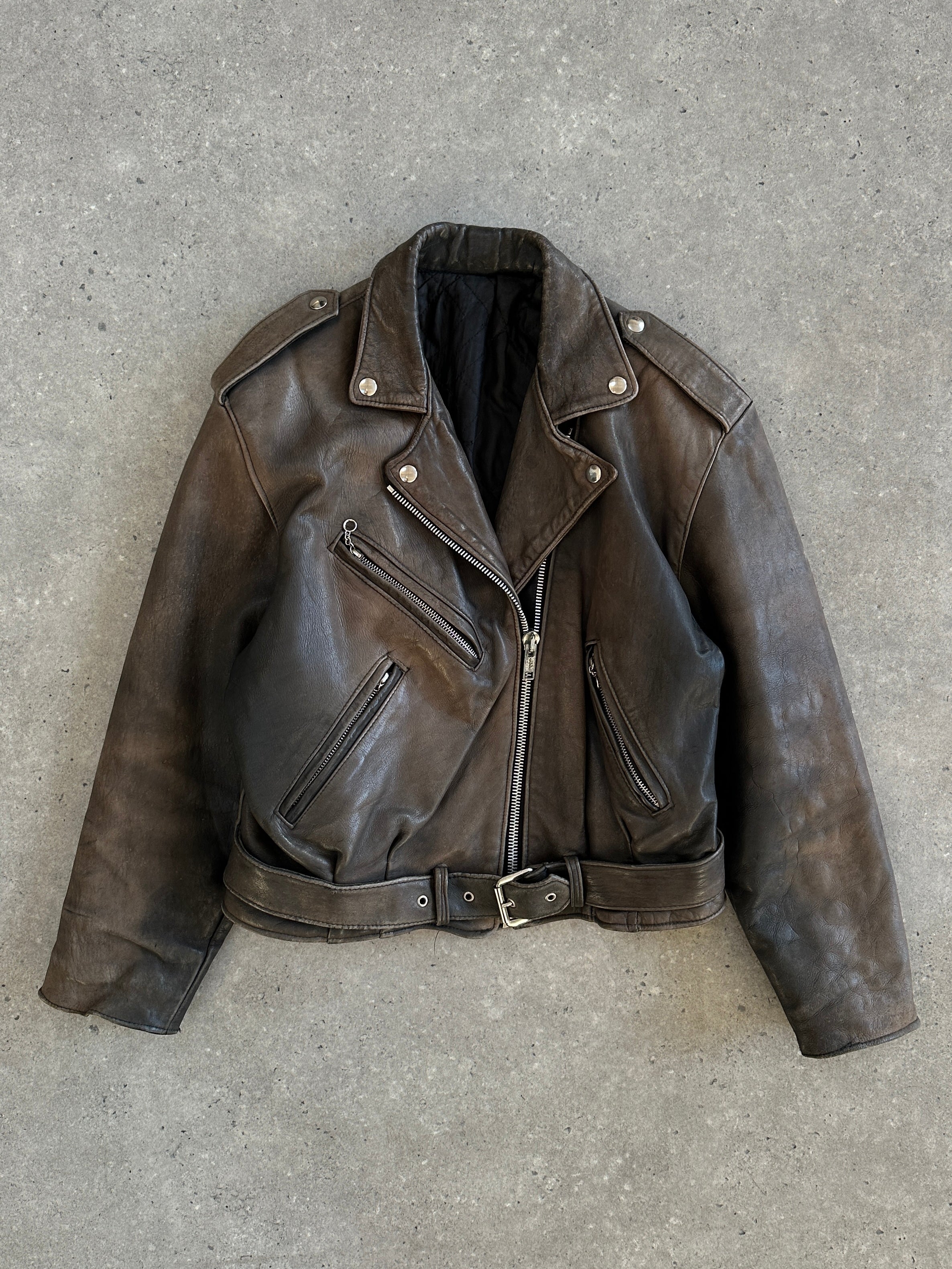 Vintage 1980s distressed leather biker jacket in size S, featuring rugged style and classic motorcycle-inspired design.