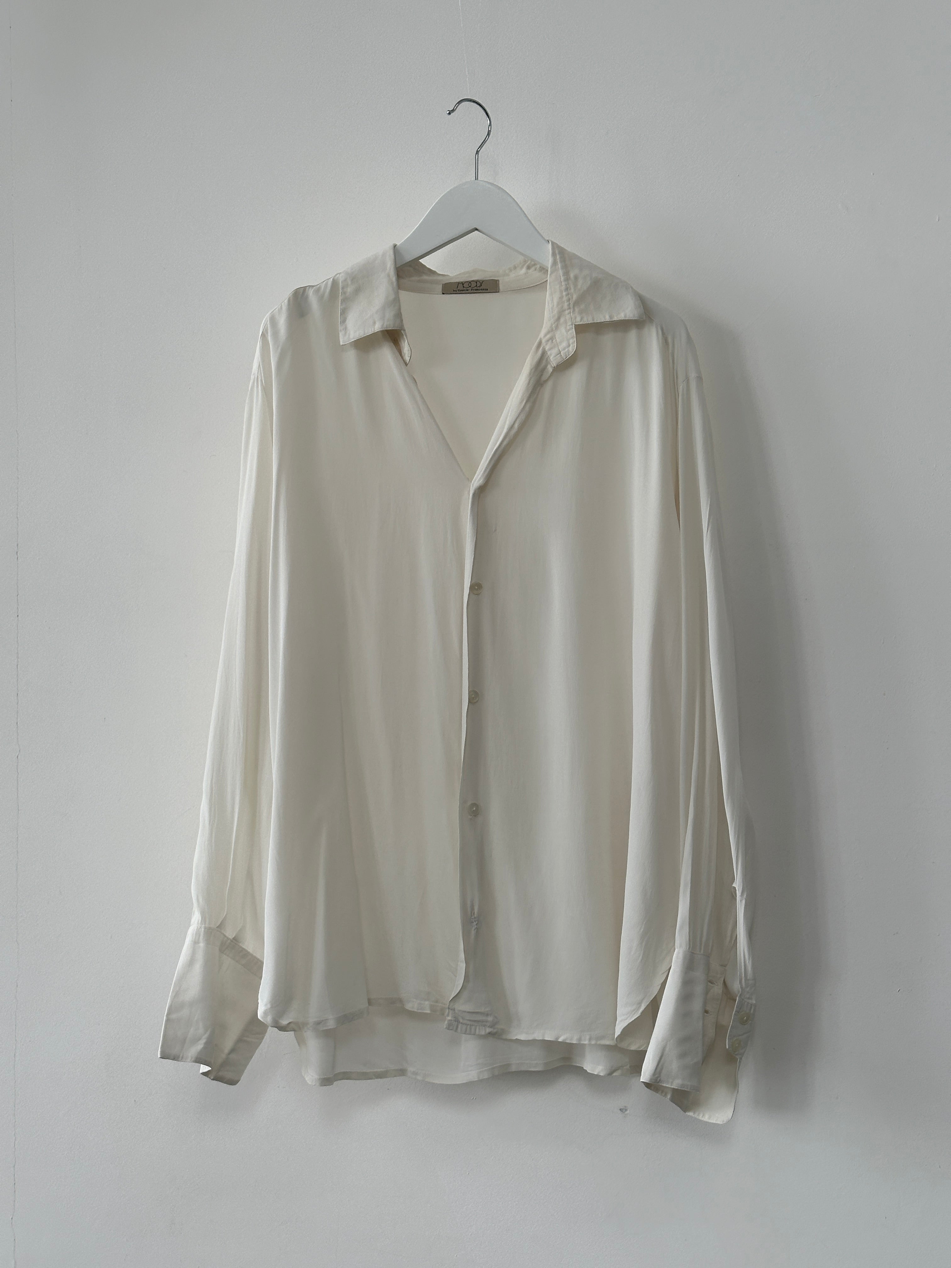 Vintage silk flowy shirt in size L, featuring a relaxed fit and elegant drape, displayed on a hanger.