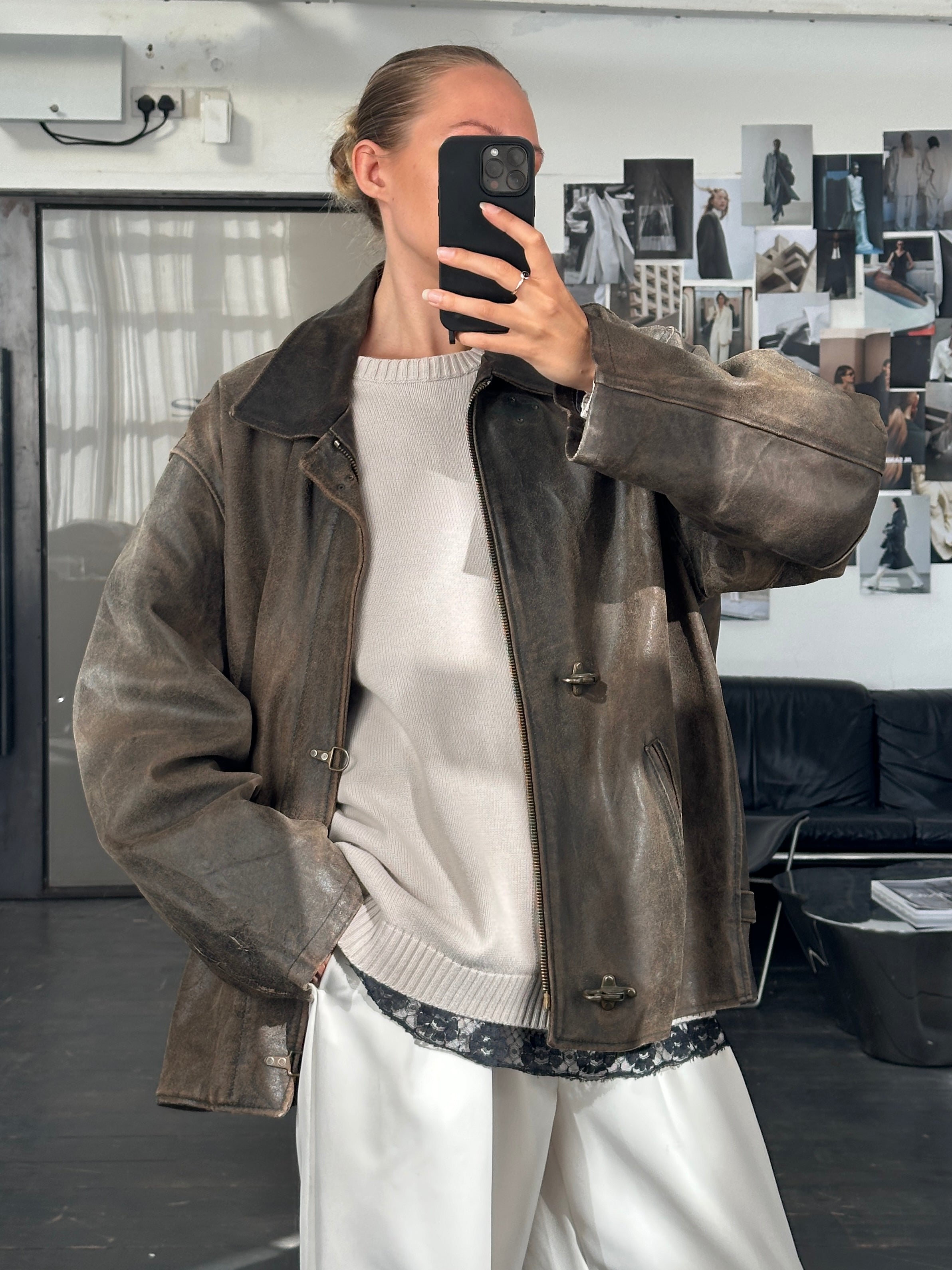 Vintage 1980s distressed leather jacket, XL size, featuring worn leather and classic styling, displayed on a neutral background.