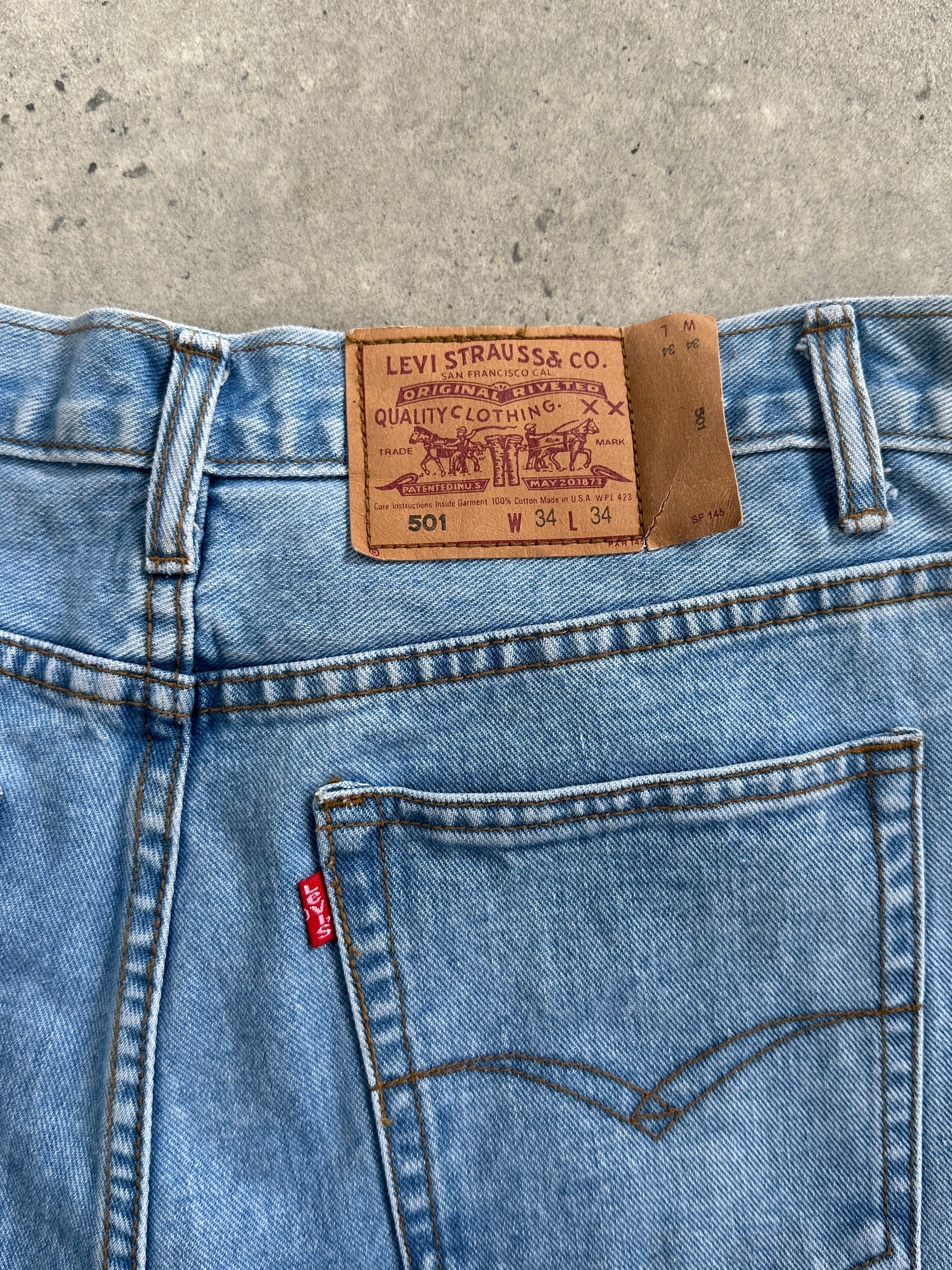Levi’s 501 light wash straight leg denim jeans, W30, shown flat with classic five-pocket design and button fly.
