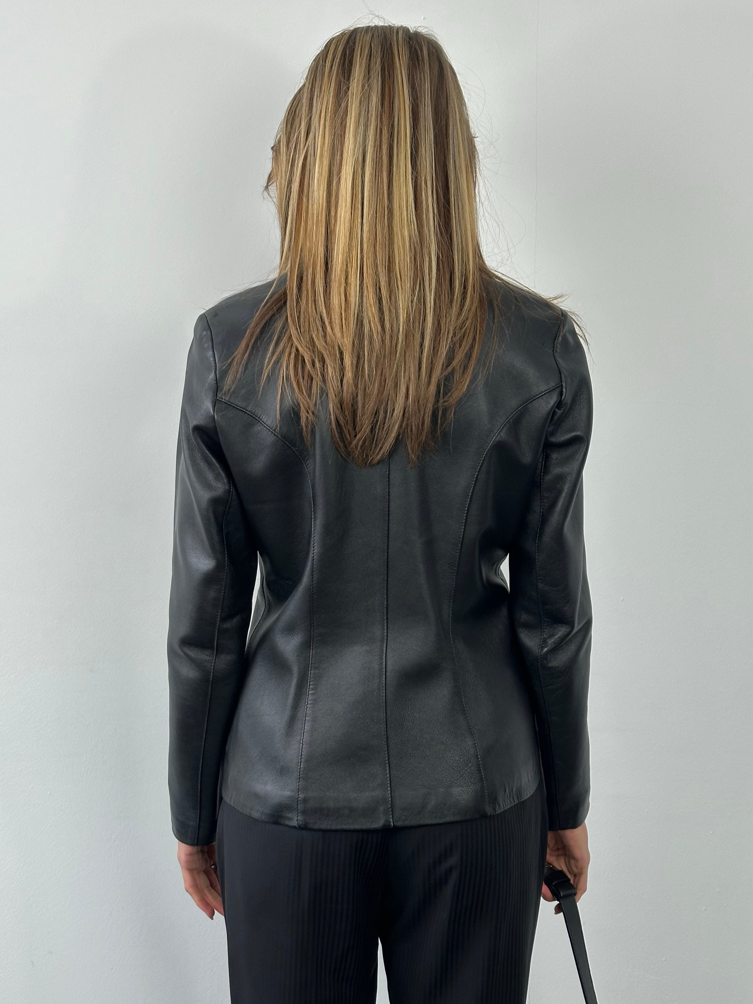 Vintage 1990s fitted leather jacket in black, showcasing classic style and detailed craftsmanship from the Vintage brand.