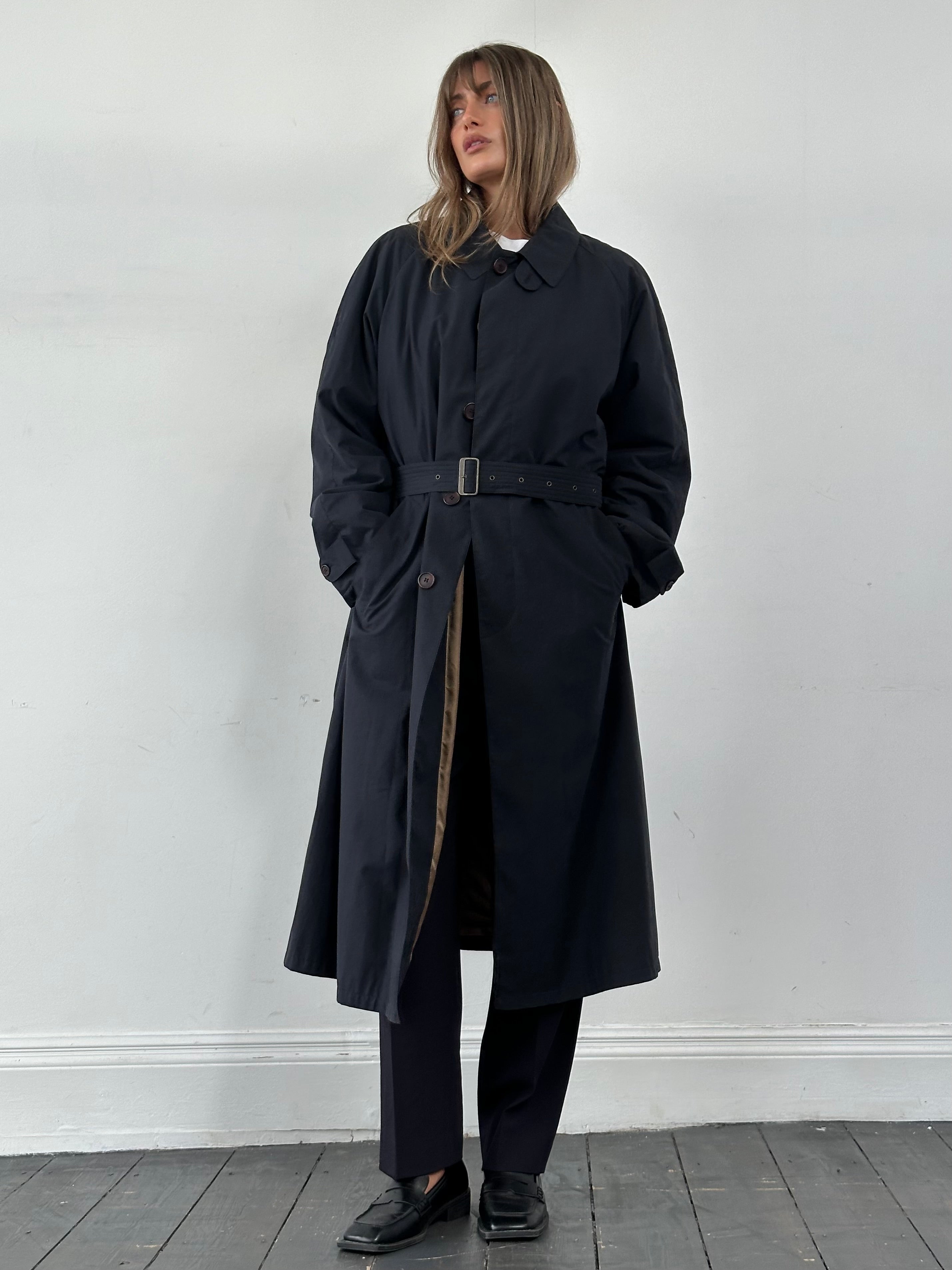 Giorgio Armani Le Collezioni cotton belted trench coat in XL displayed on a hanger, showcasing classic design and neutral color.