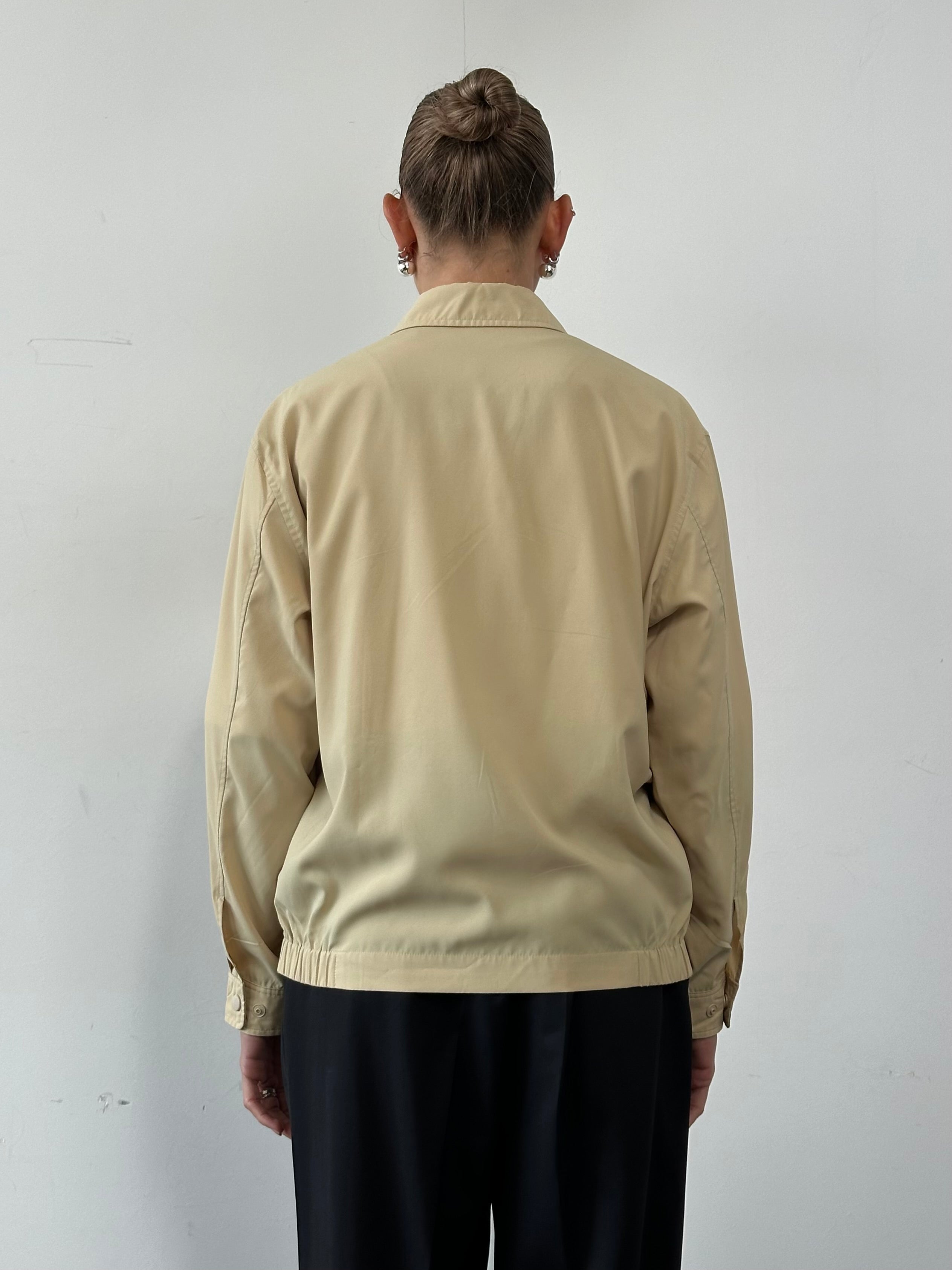 Yves Saint Laurent Pour Homme logo bomber jacket in black, front view showing classic design and brand logo on chest.