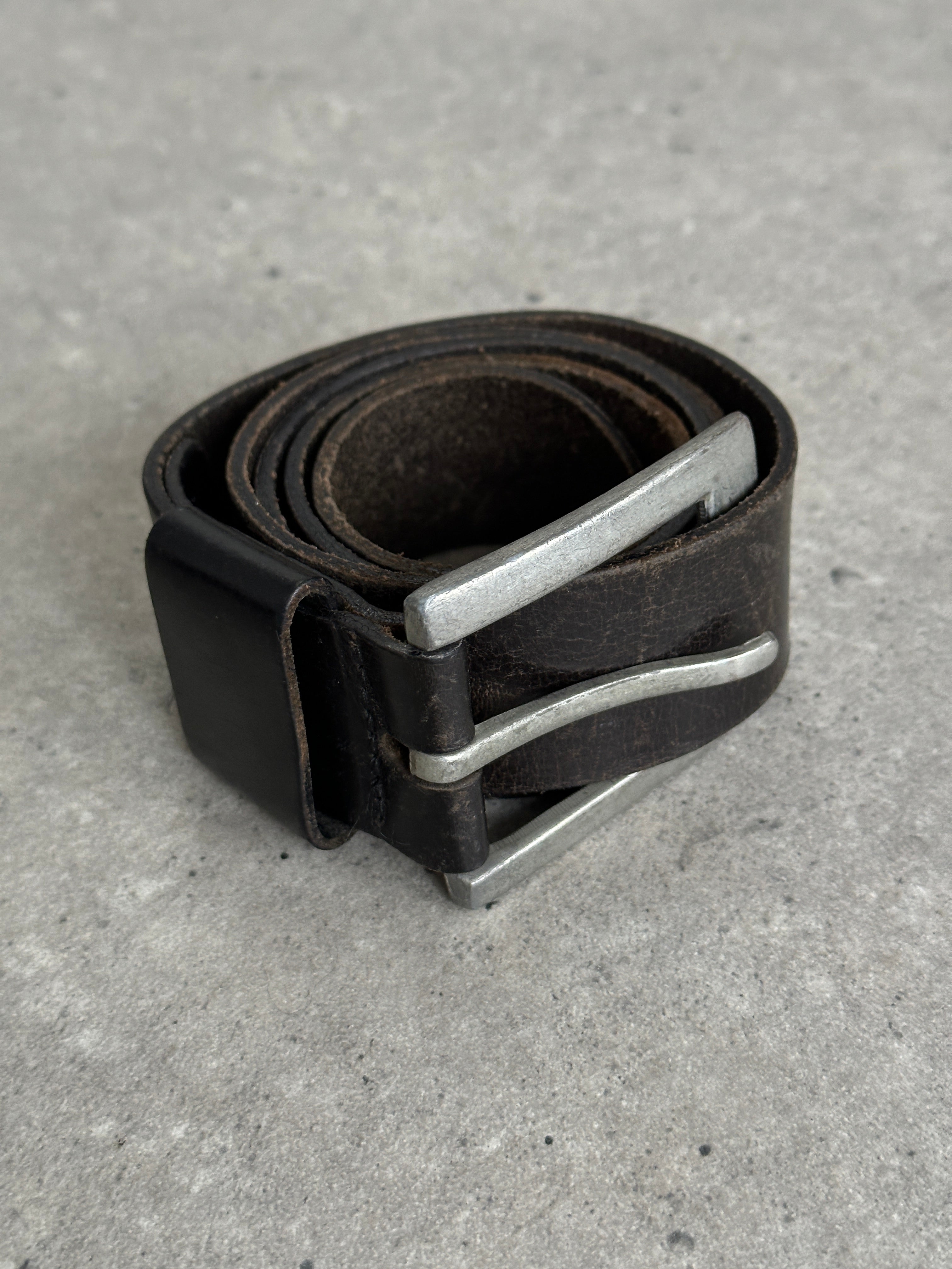 Vintage distressed leather belt in size W34-37, featuring a rugged, worn-in look and classic buckle detail.