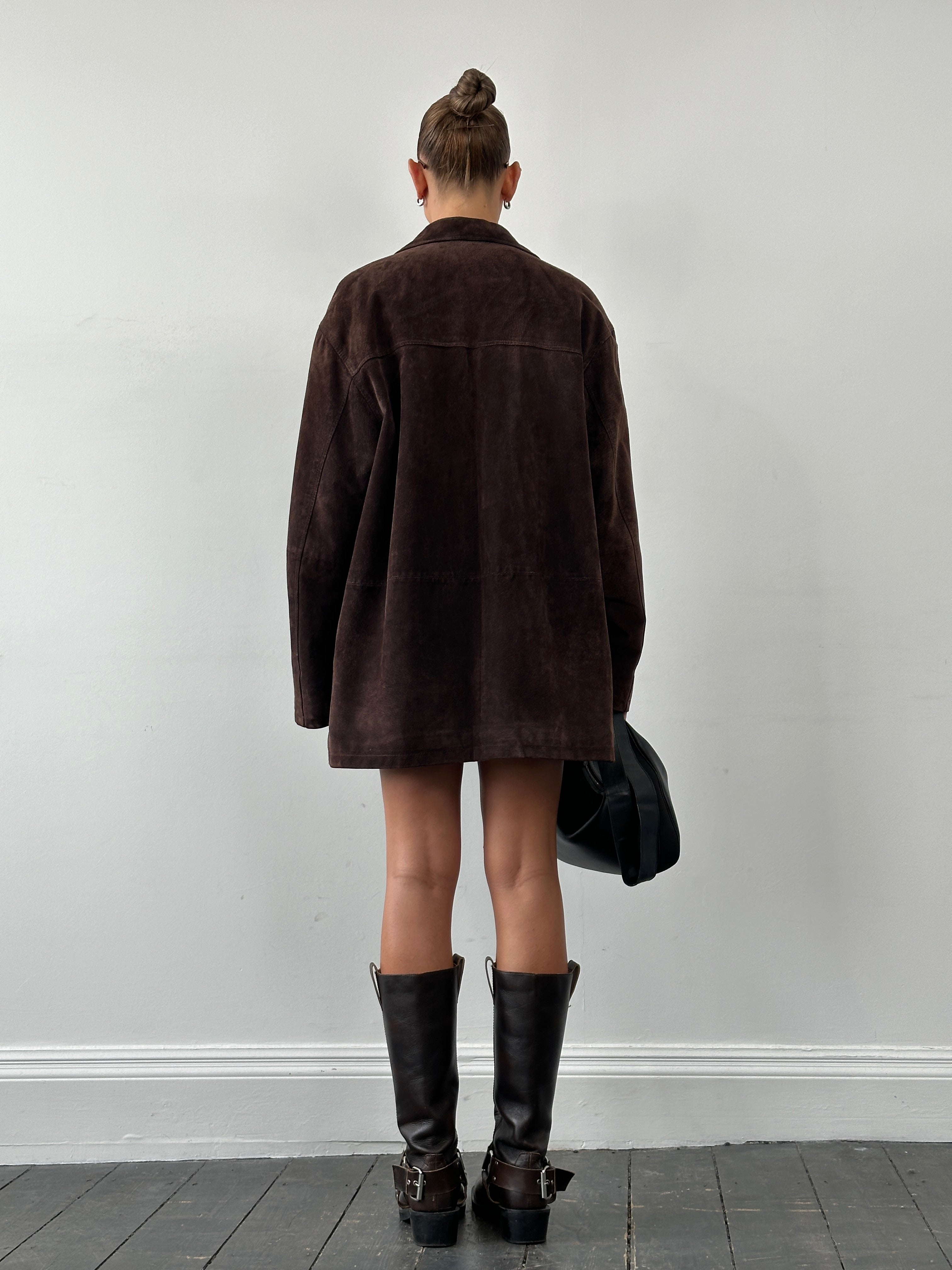 Balmain mid-length suede jacket in XL displayed on a hanger, showing its rich texture and stylish design.