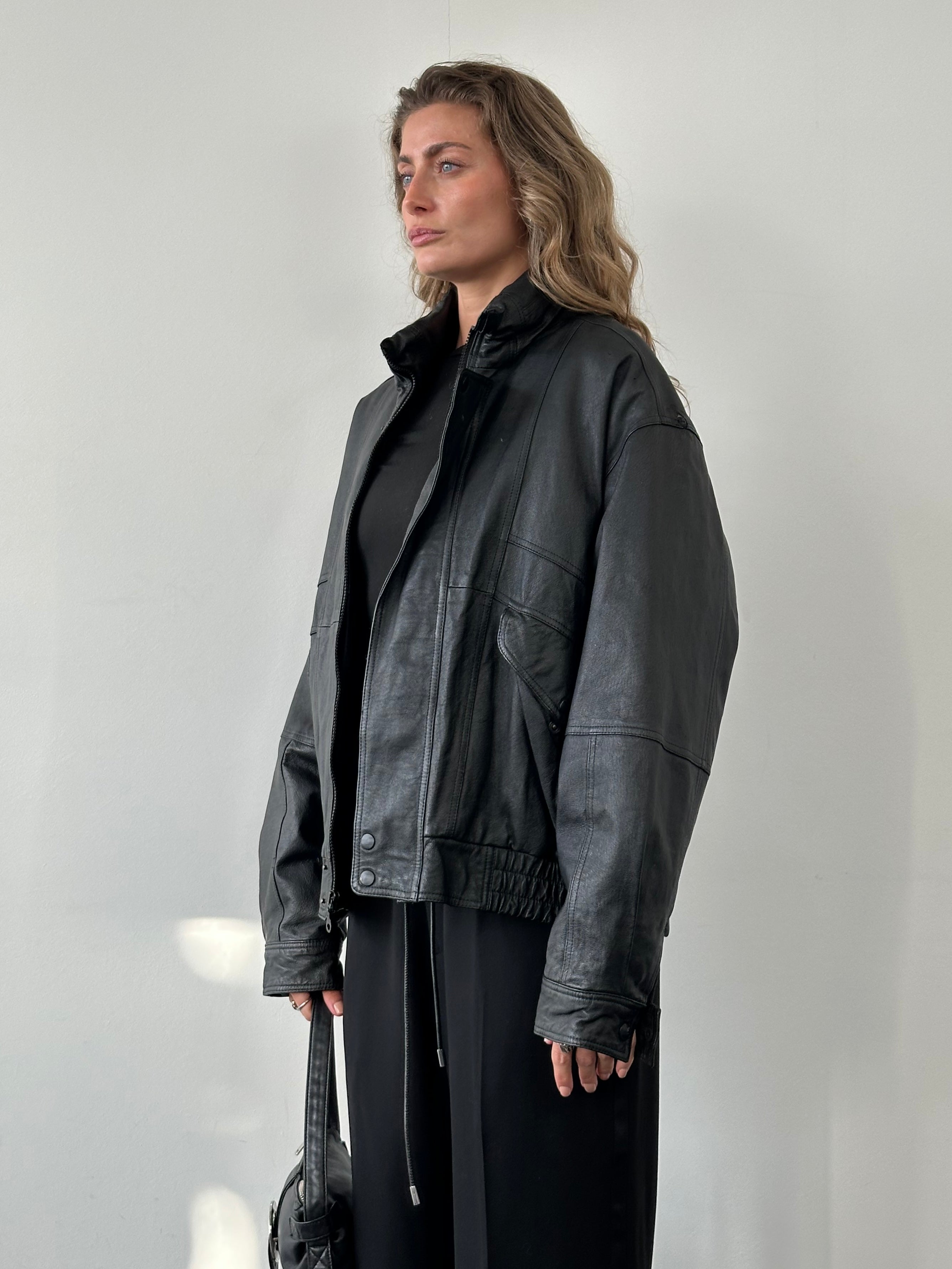 Vintage Leather Bomber Jacket in size L, featuring classic design with a rugged leather finish and detailed stitching.