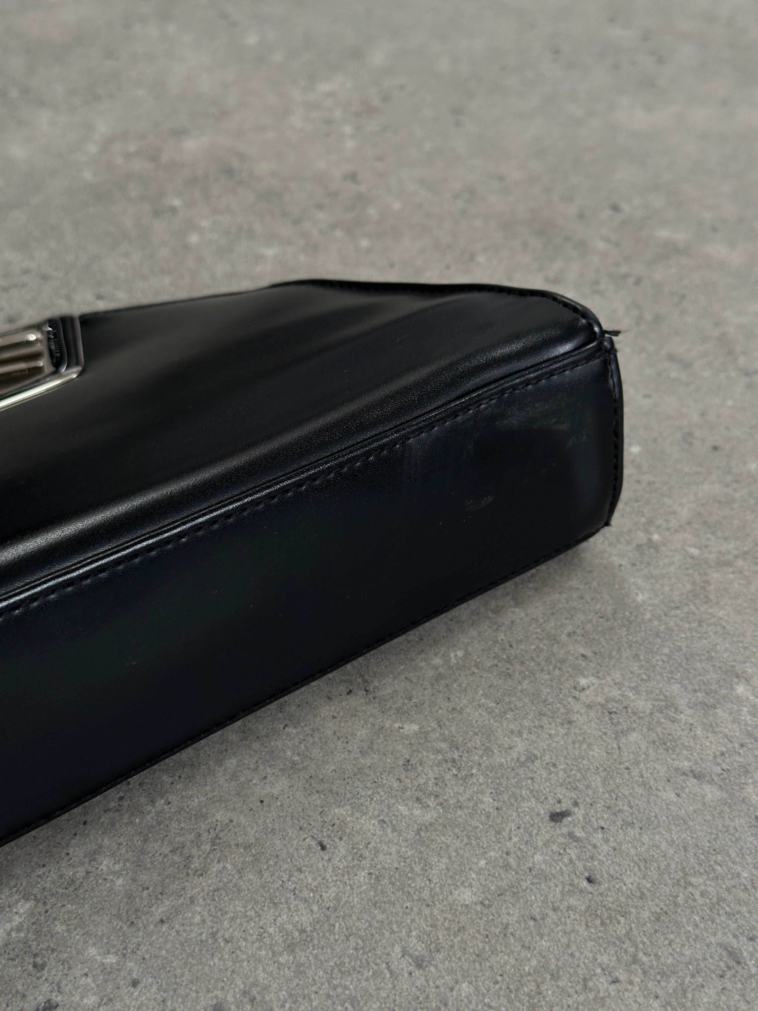 Vintage leather chrome crossbody clutch bag with adjustable strap and sleek design, perfect for stylish everyday use.