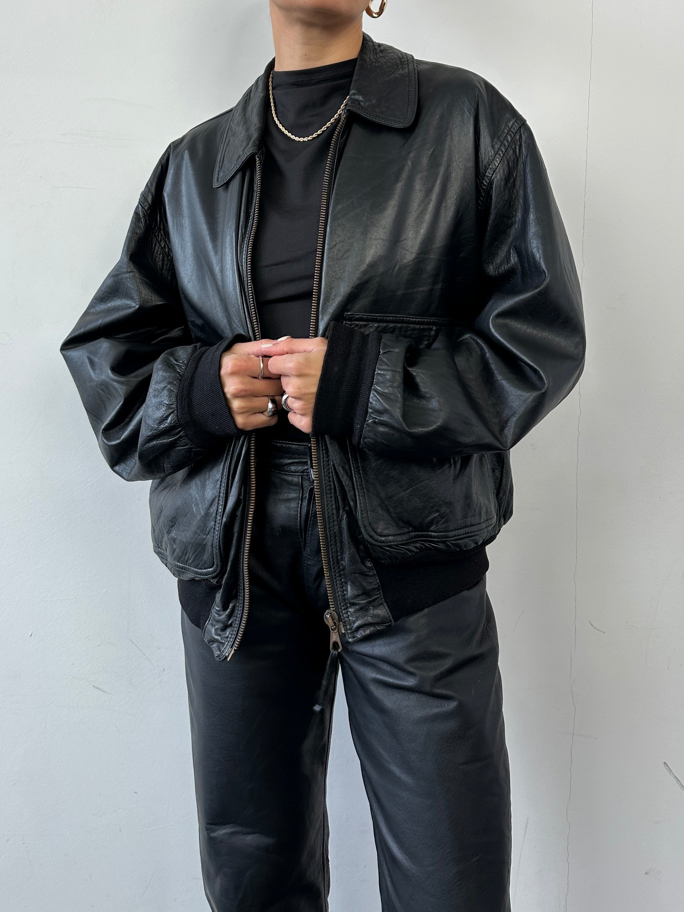 Vintage brand vintage leather bomber jacket in size large with classic design and detailed stitching.