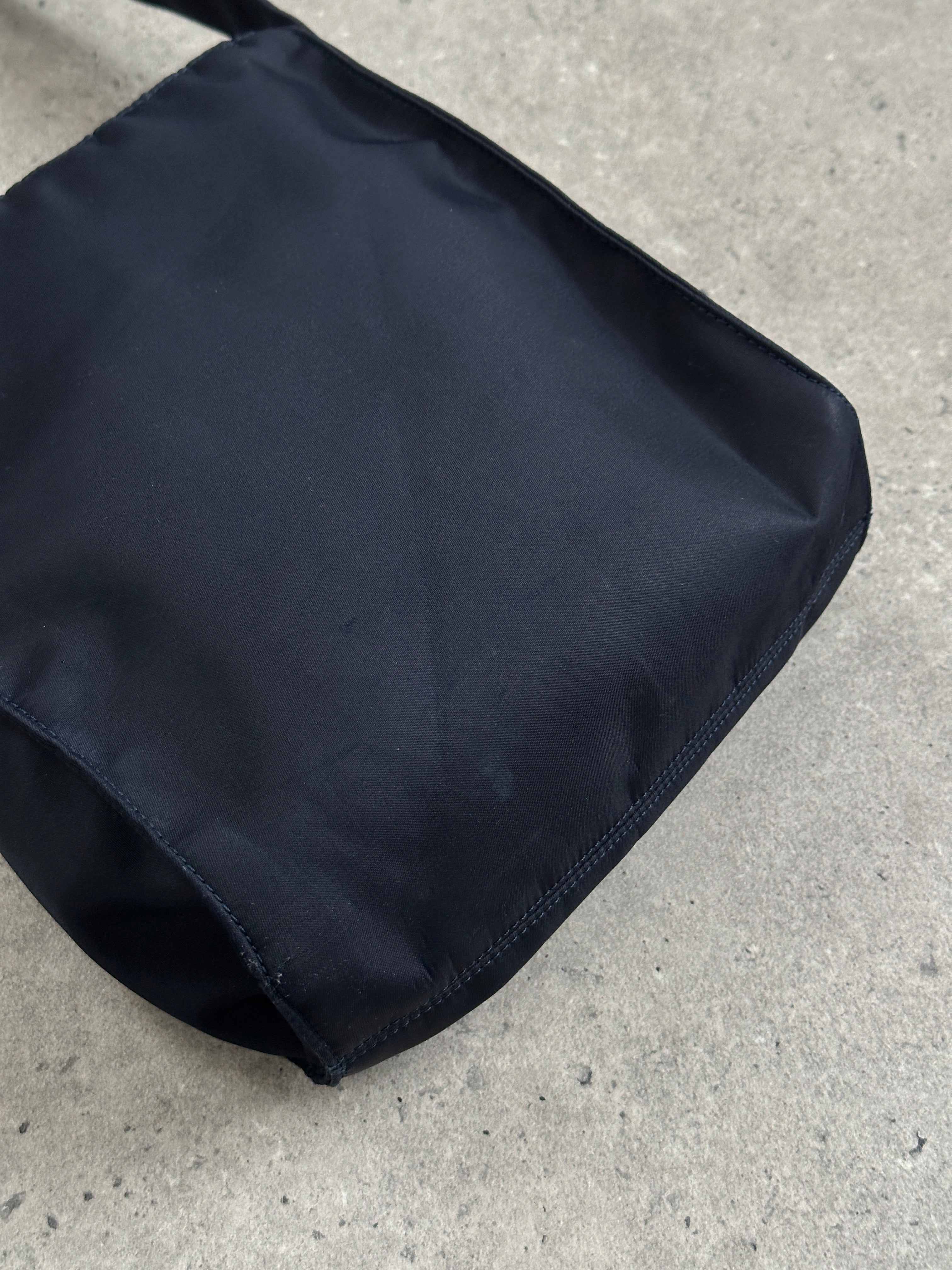 Armani Jeans 2000s nylon shoulder bag with adjustable strap and sleek design, featuring the Armani logo on the front.