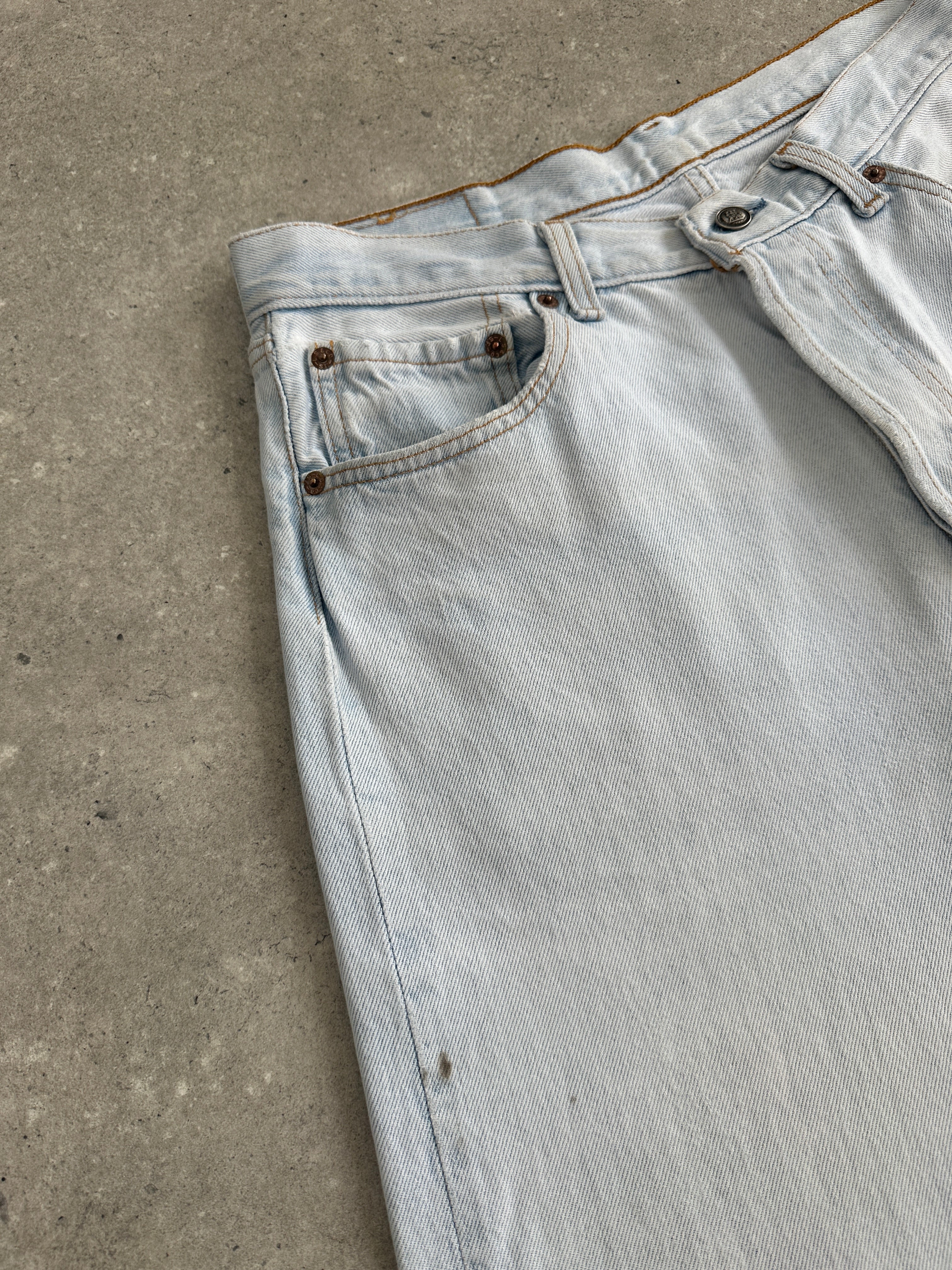 Levi’s 501 light wash straight leg denim jeans in size W30 displayed flat, showcasing classic fit and durable denim fabric.