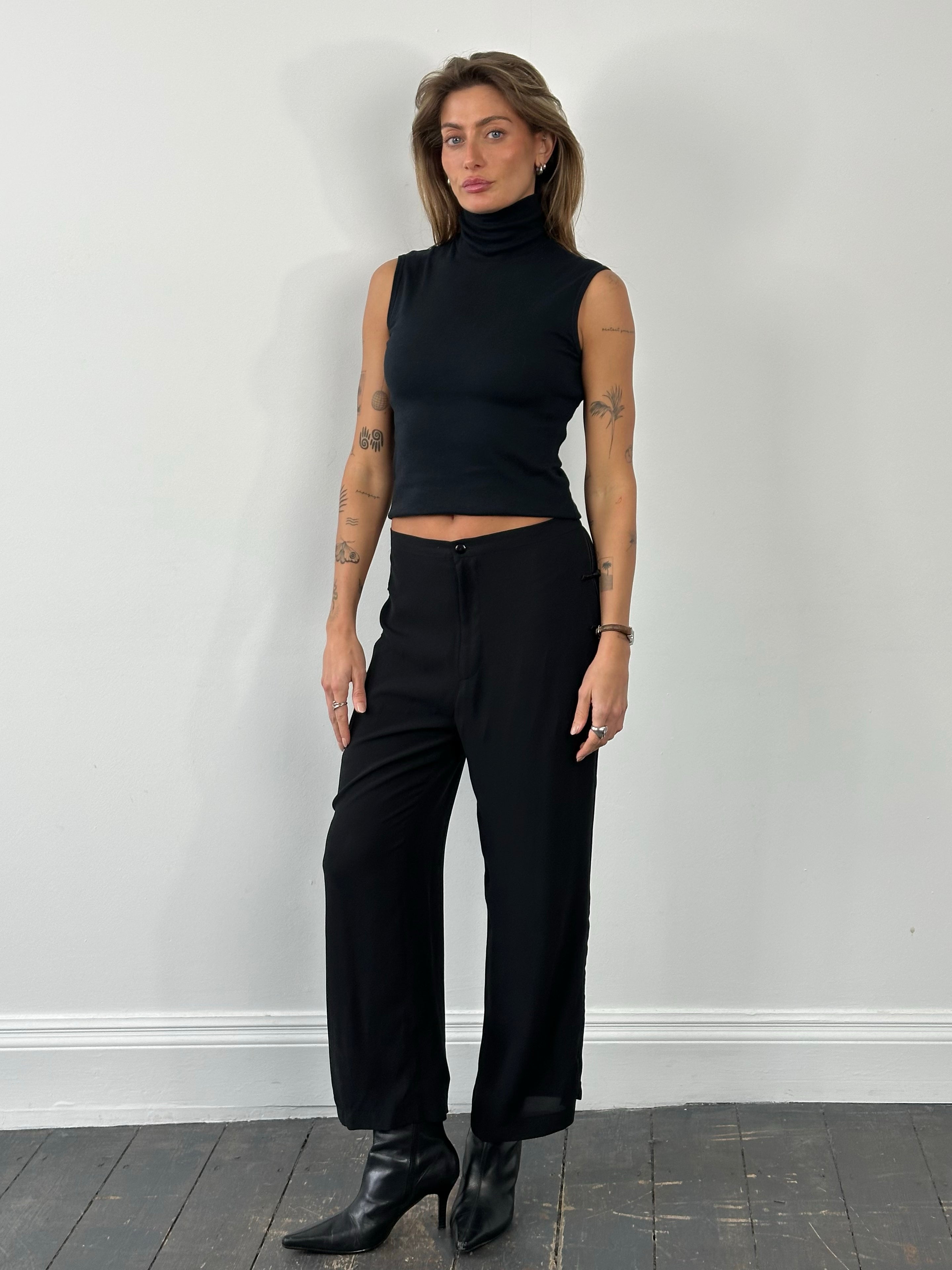 Vintage 1990s pure silk wide leg trousers in W28, showing the smooth fabric and stylish fit.