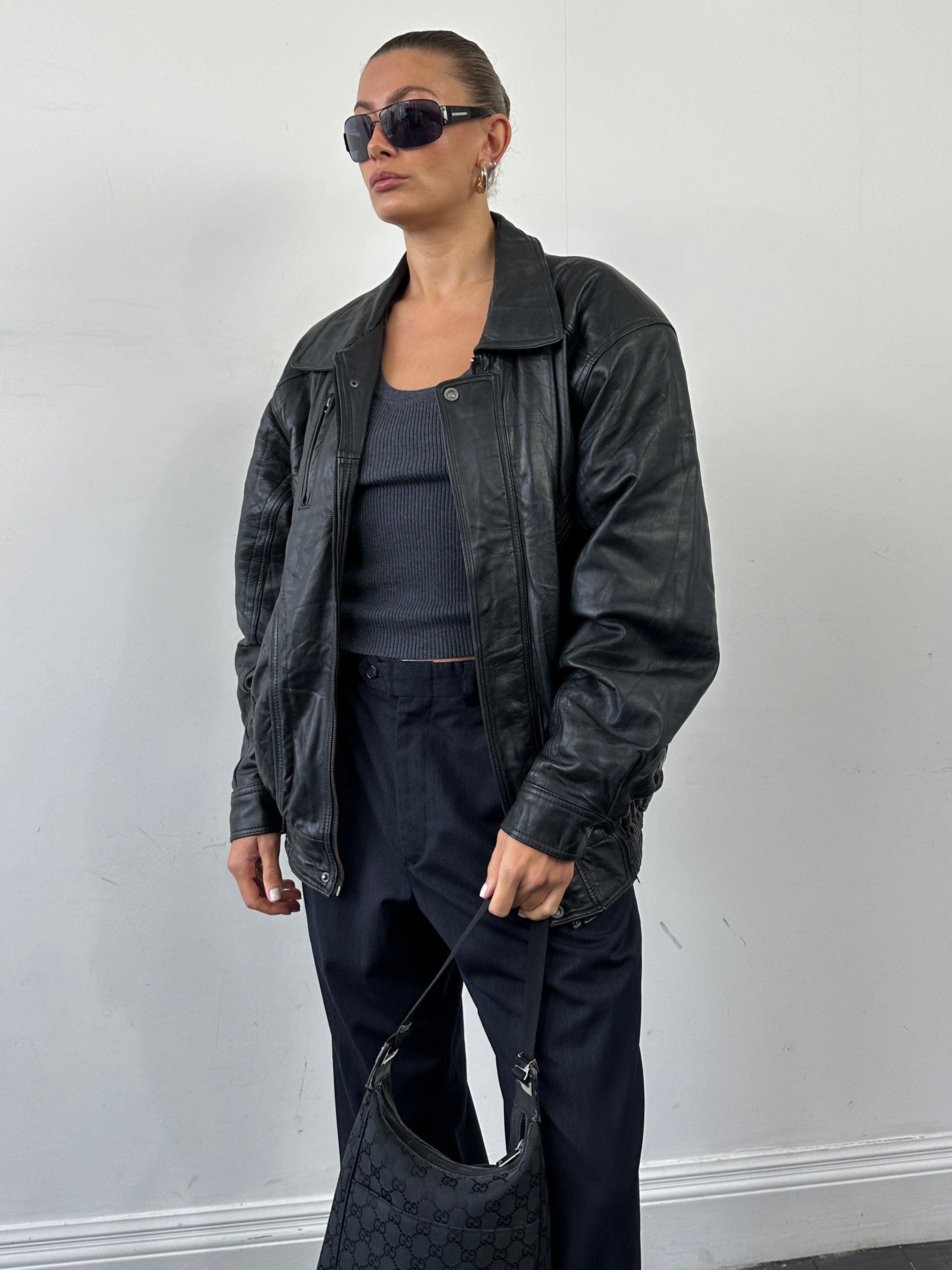 Vintage leather bomber jacket in XL size, featuring classic design, ribbed cuffs, and a smooth leather finish.