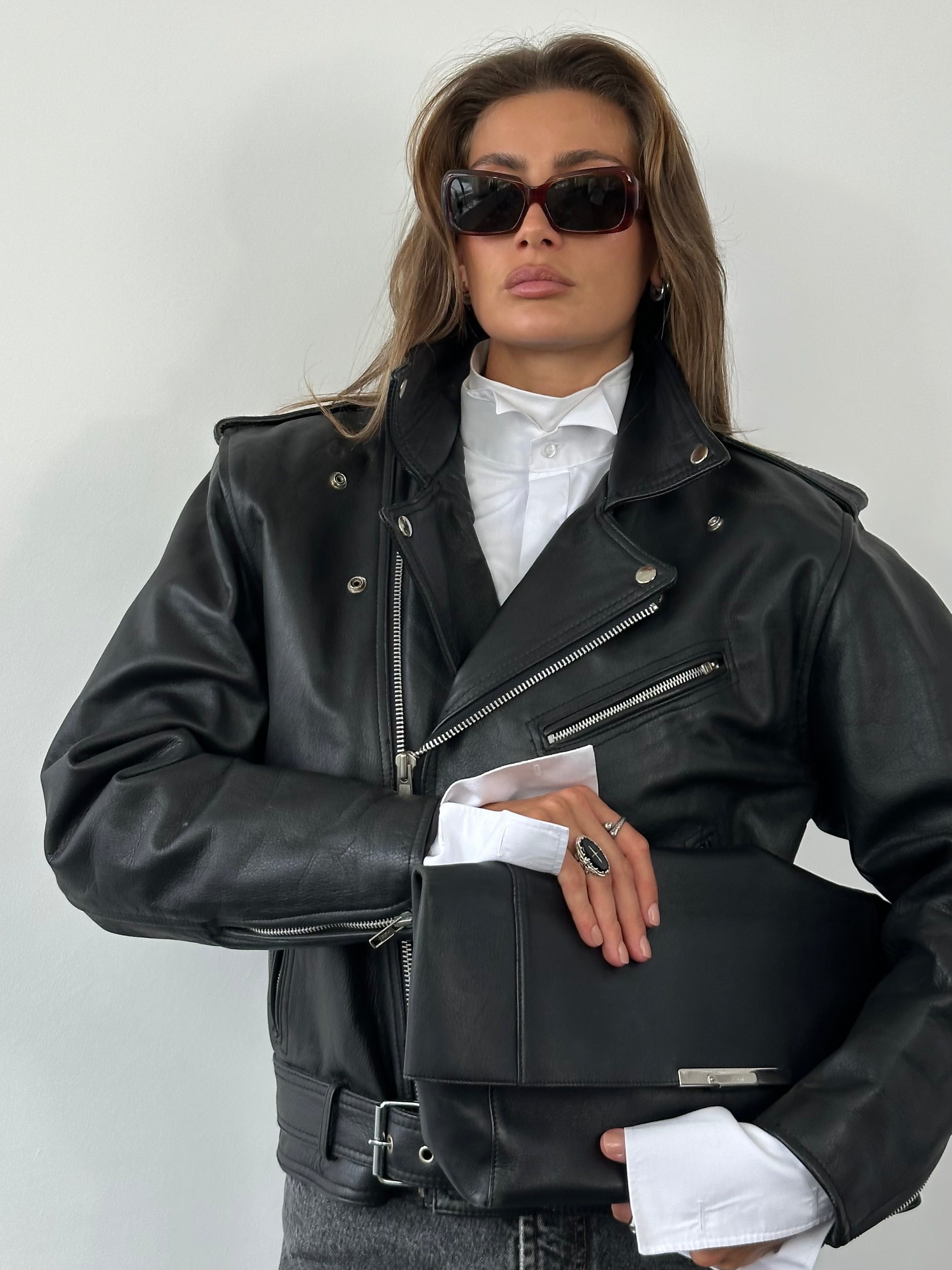 Vintage 1990s leather biker jacket in size M, featuring classic design, zip front, and distressed leather detail.