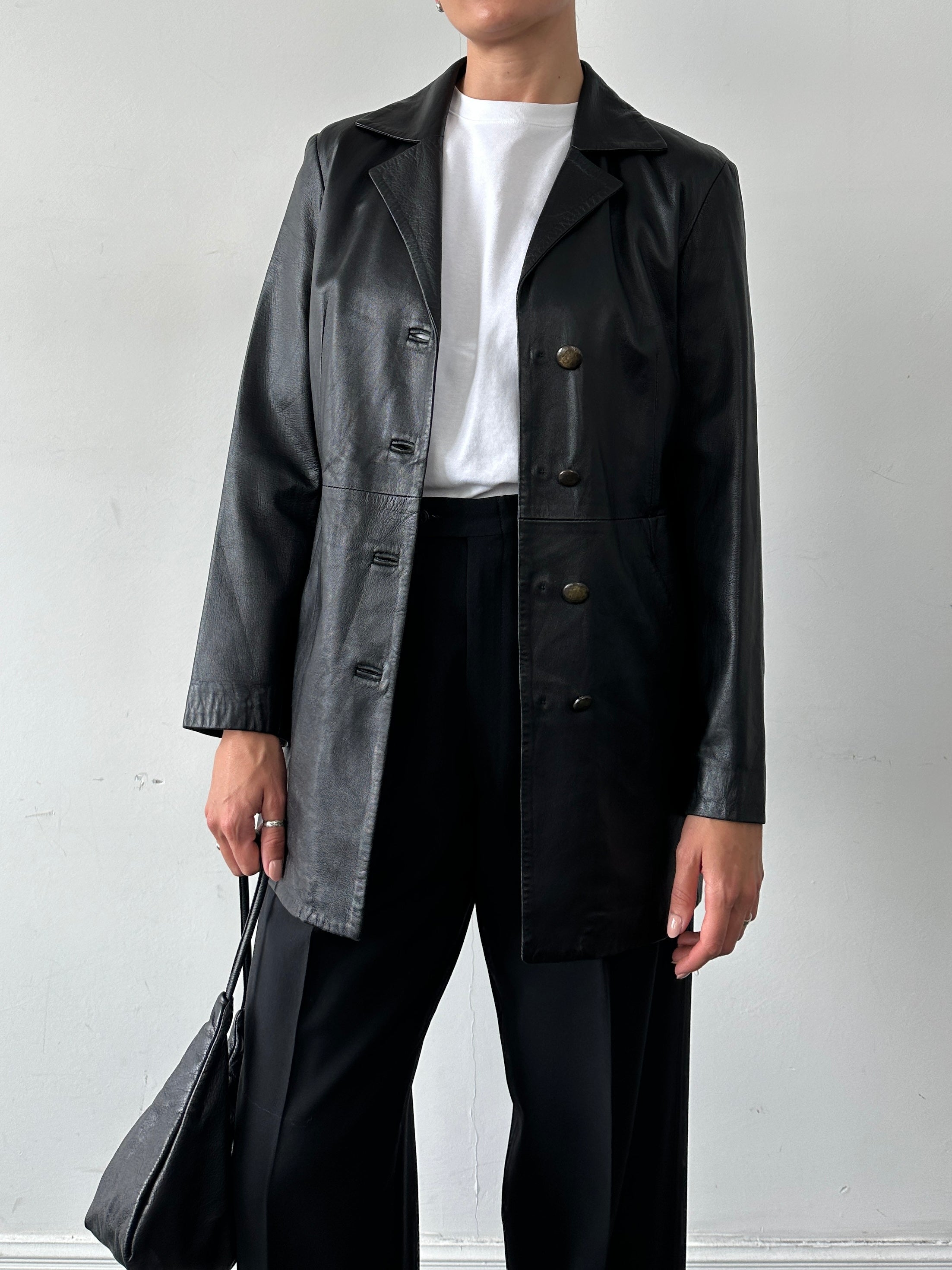 Vintage Italian longline smooth leather jacket for women, stylish and timeless, shown in a natural long profile.