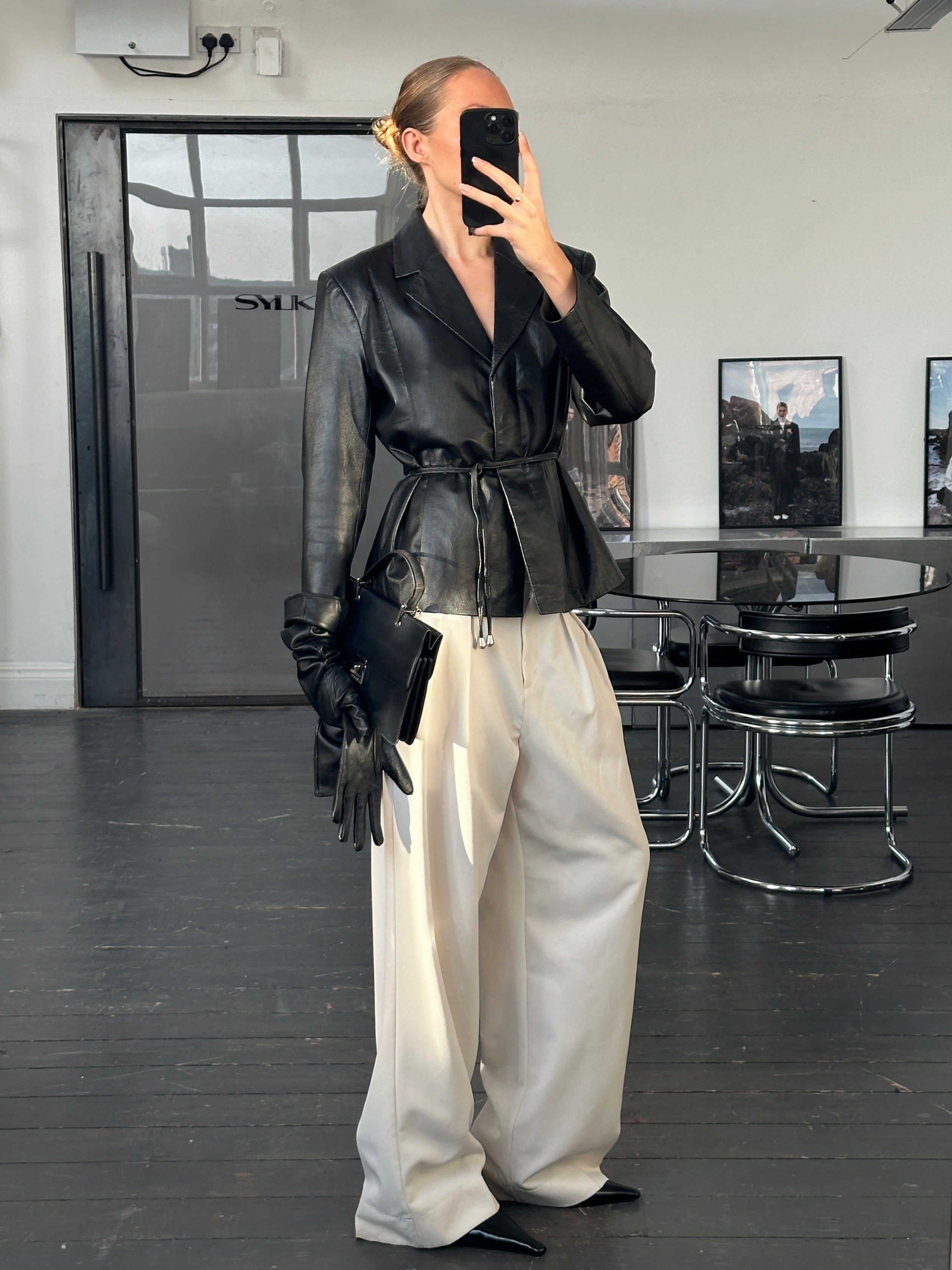 Vintage 2000s leather jacket with rope tie belt, showcasing classic style and textured leather detail.