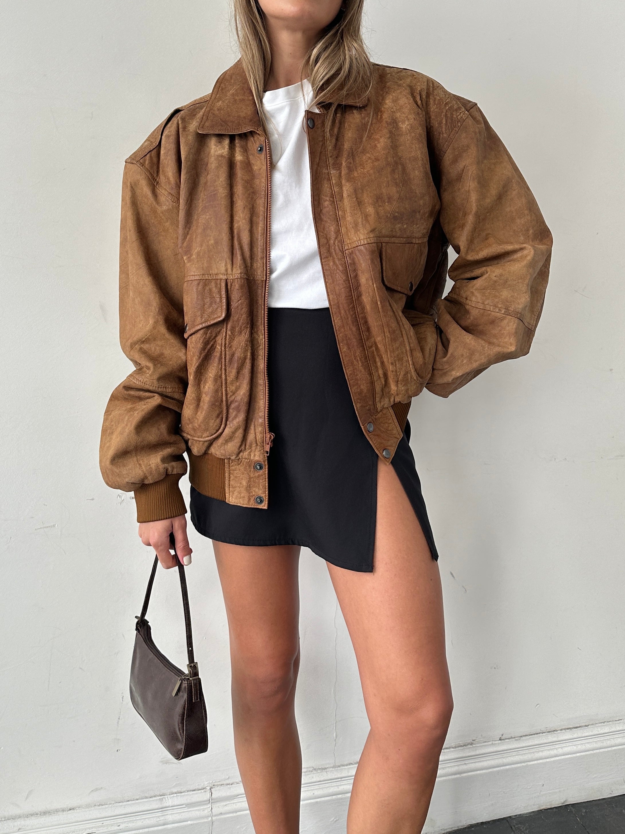 Vintage aged leather bomber jacket in XL with distressed finish, featuring classic collar and zip closure, stylish and durable.