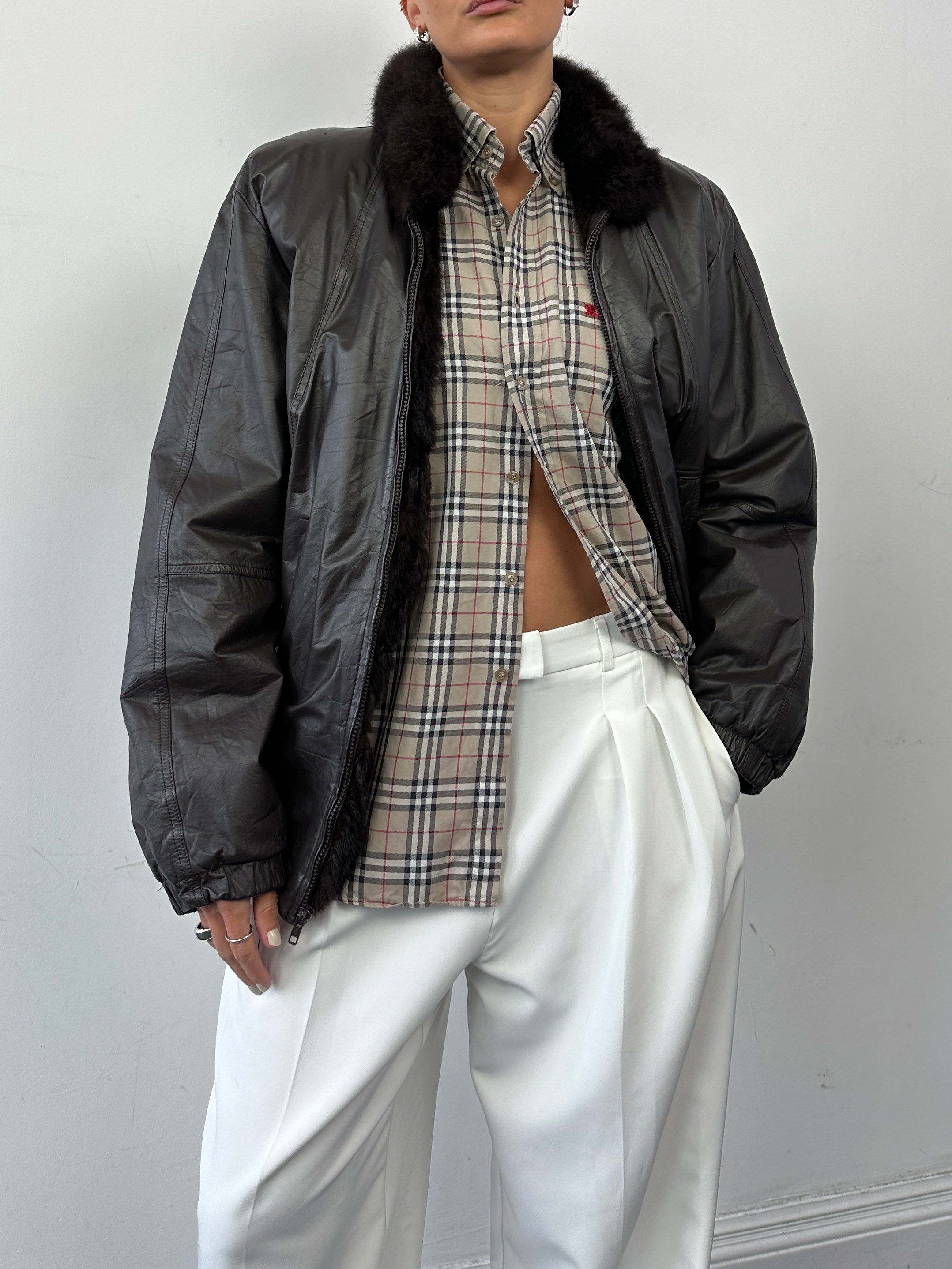 Vintage leather bomber jacket with faux fur lining, minimal design, size small, stylish and warm for casual wear.