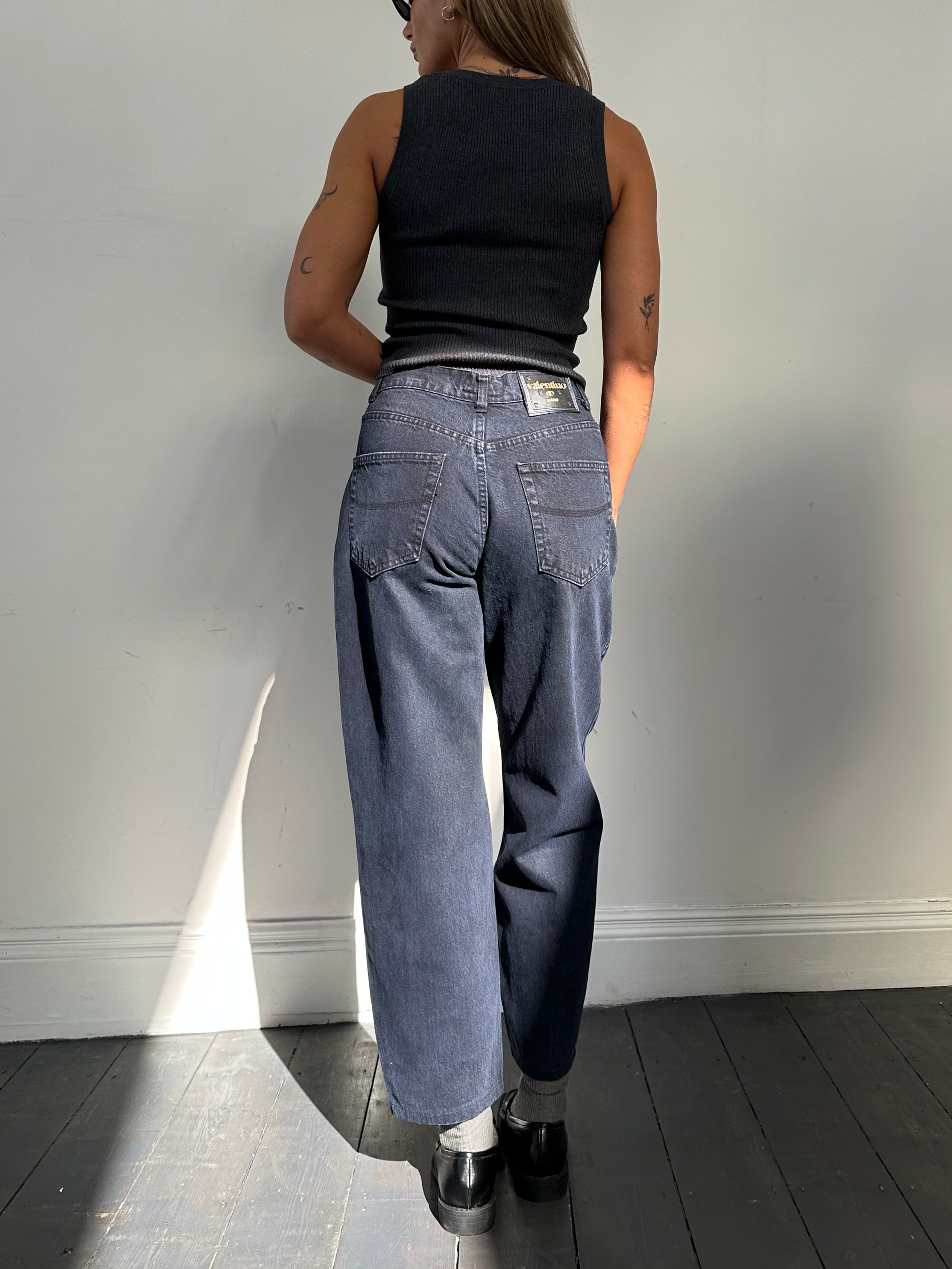 Valentino tapered high-waisted denim jeans in size W28, featuring classic blue wash and fitted silhouette.