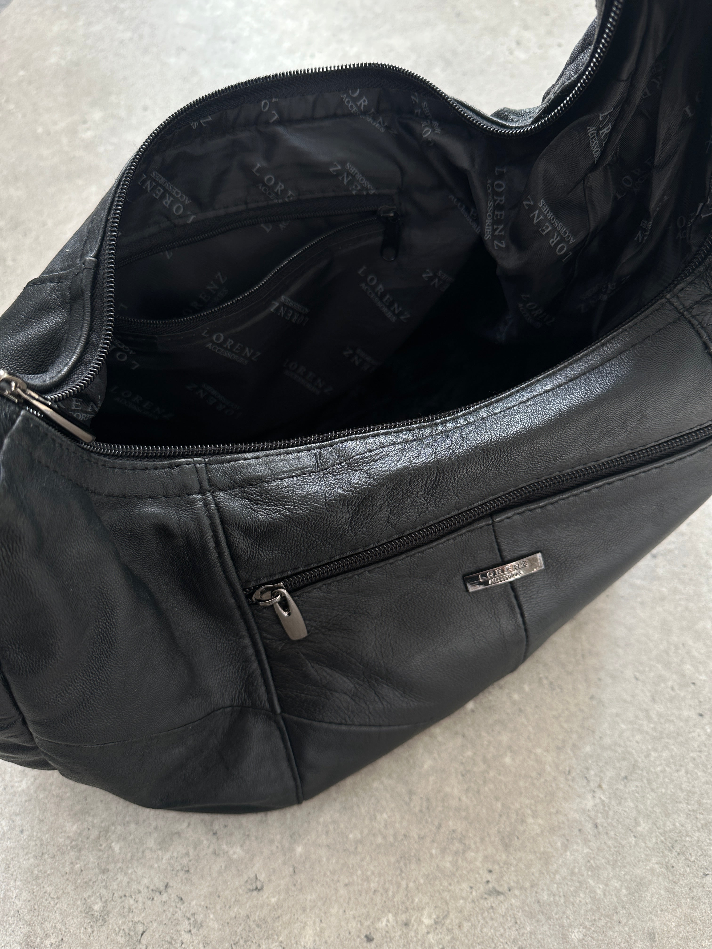 Vintage leather patchwork sling crossbody bag with adjustable strap and multiple compartments, showcasing a unique vintage design.