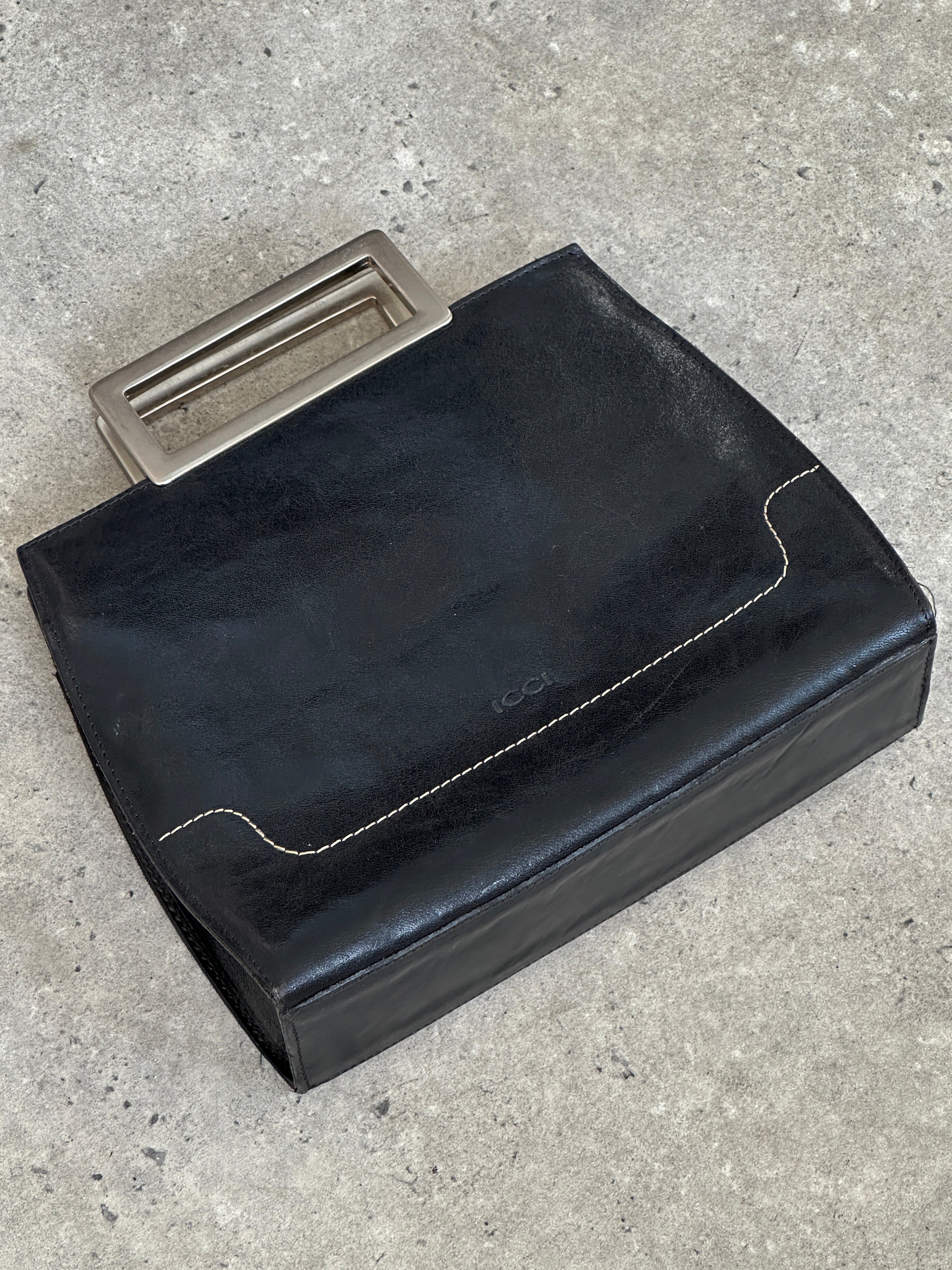Vintage 1990s leather bag with adjustable strap and classic design, featuring worn brown leather and vintage detailing.