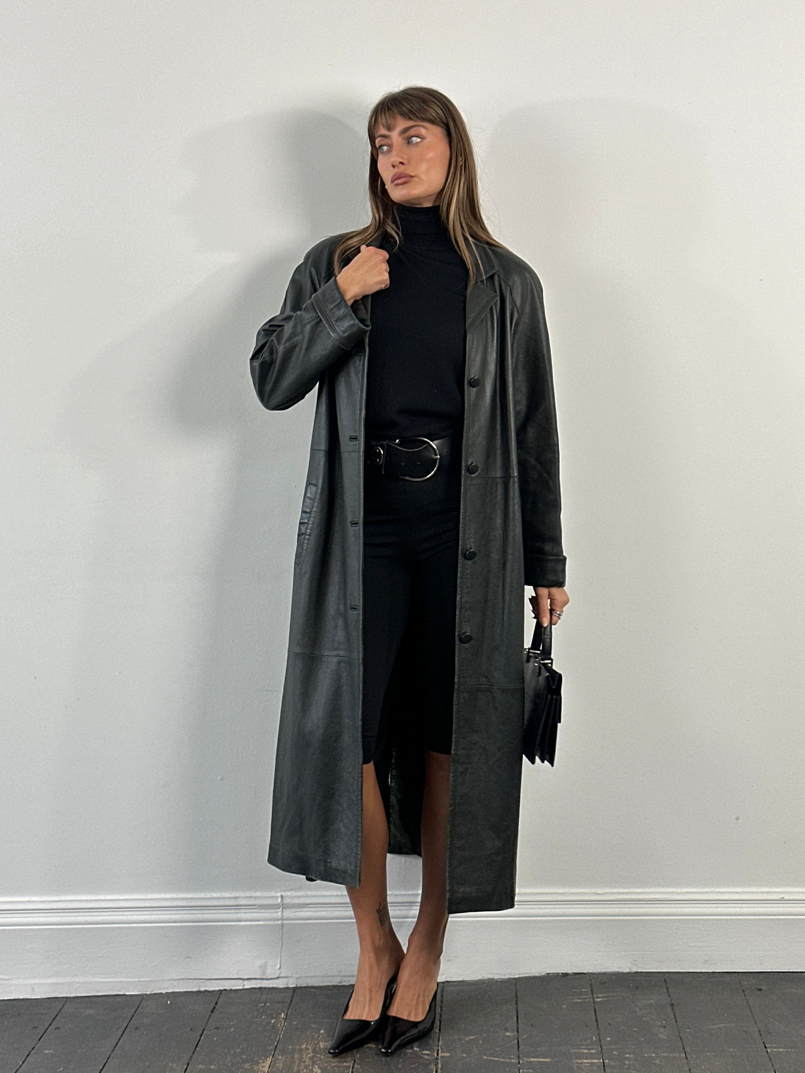 Vintage 1990s leather trench coat jacket, floor length, vintage style, in size large, displayed on a hanger.