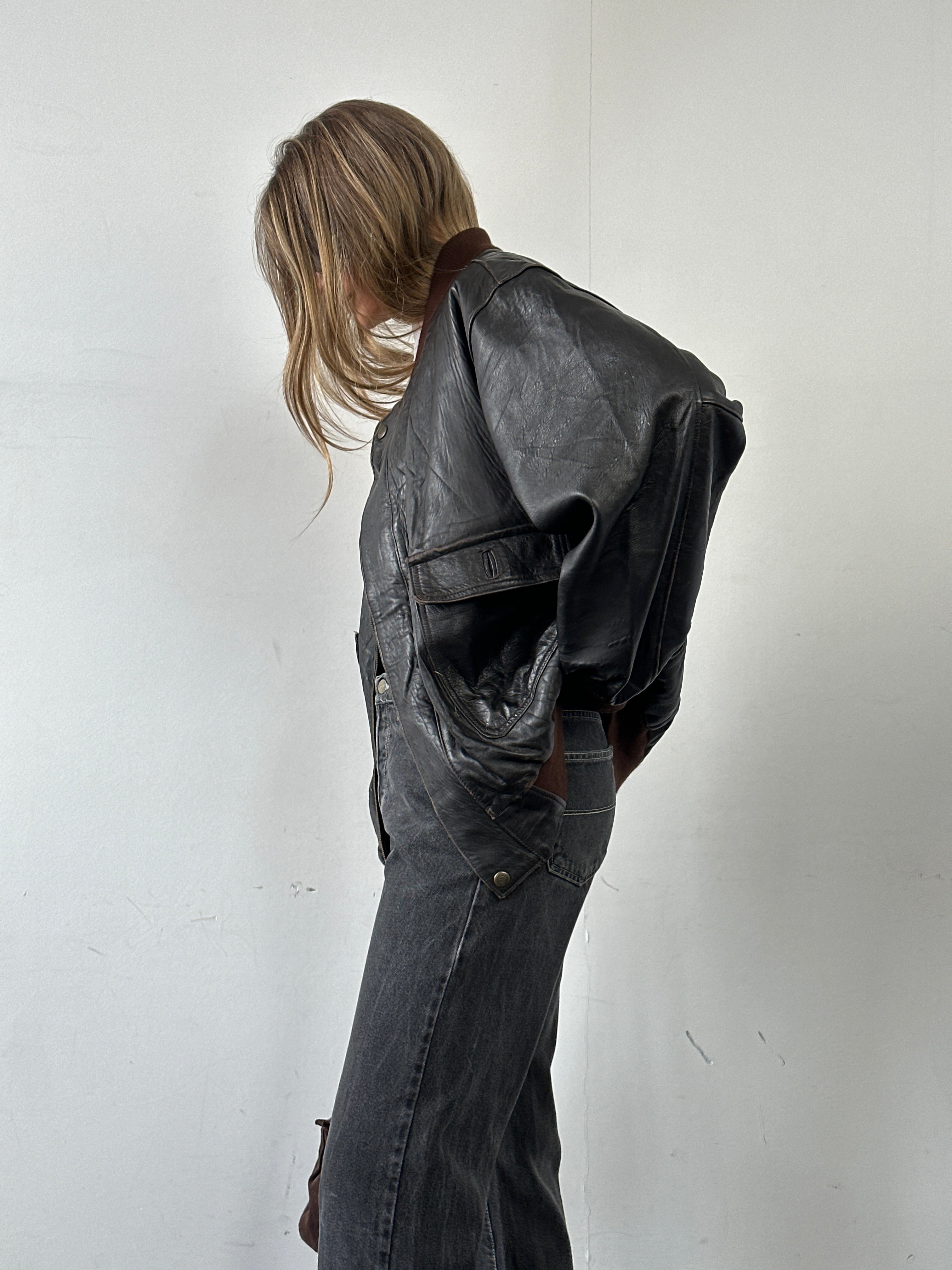 Italian vintage aged leather bomber jacket in XL size with distressed finish and classic collar, styled for a rugged look.